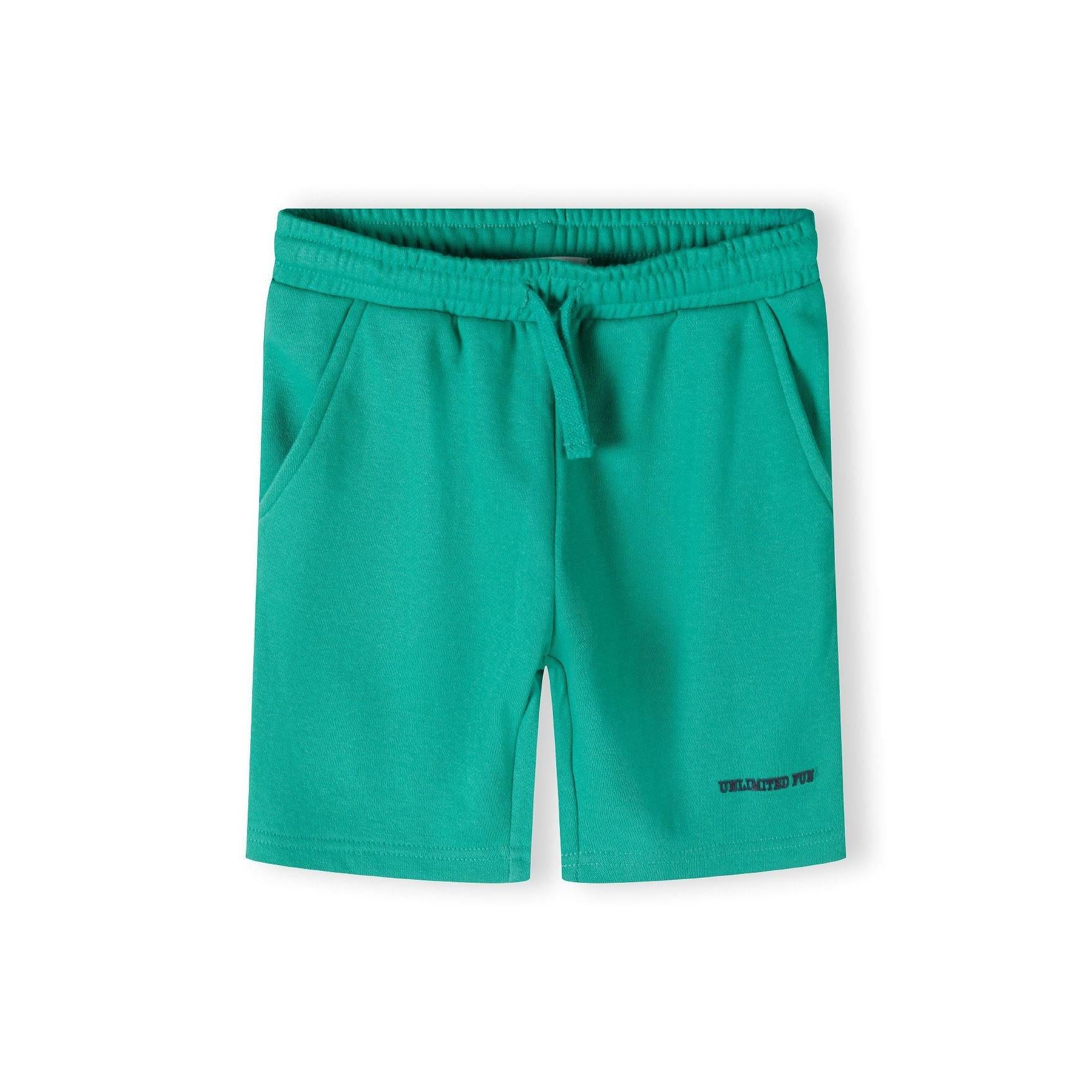 Bright green fleece shorts laid flat showing elasticated waistband and relaxed fit on white background