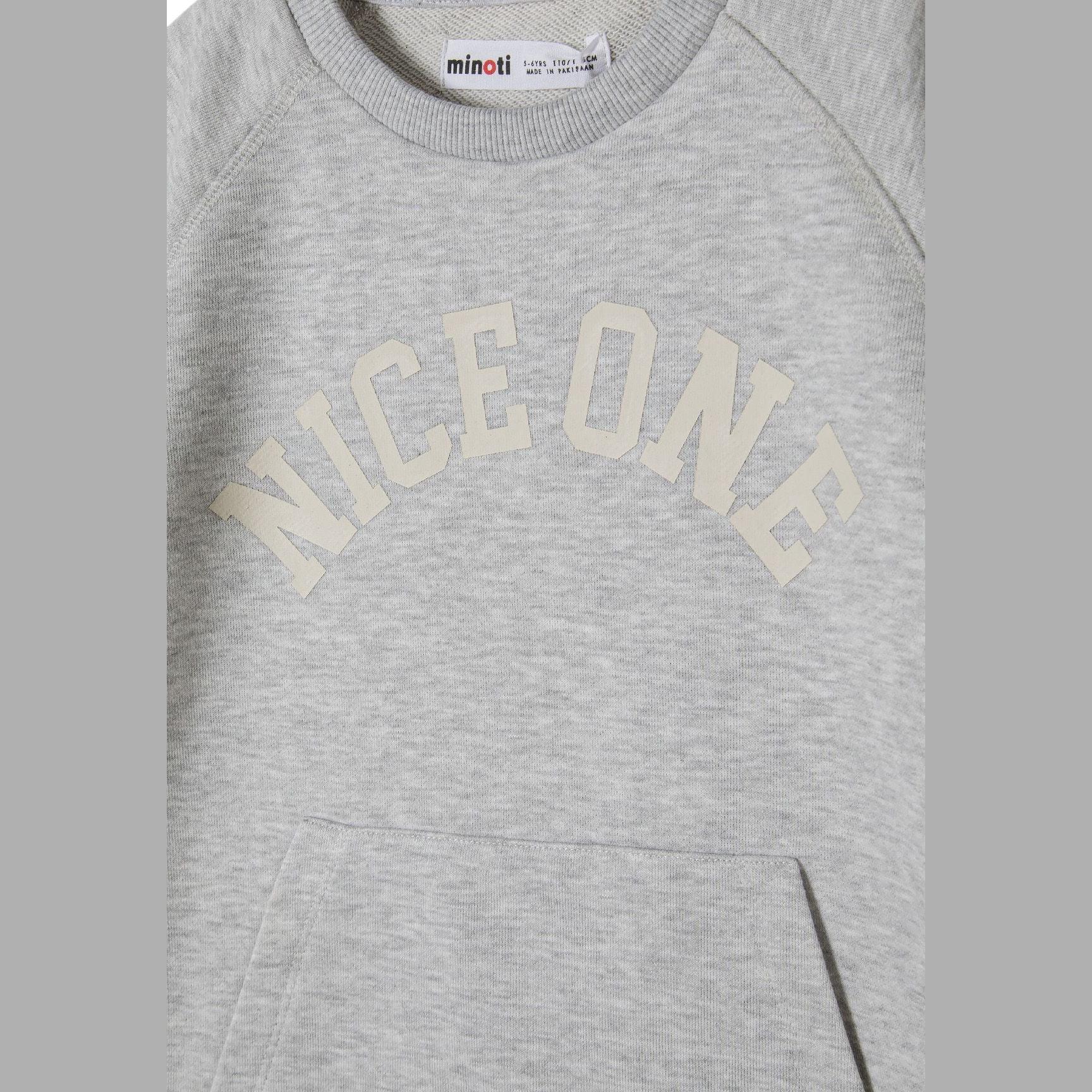 Close-up detail of grey shorts showing Nice One text print on leg and hemmed bottom edge on white background