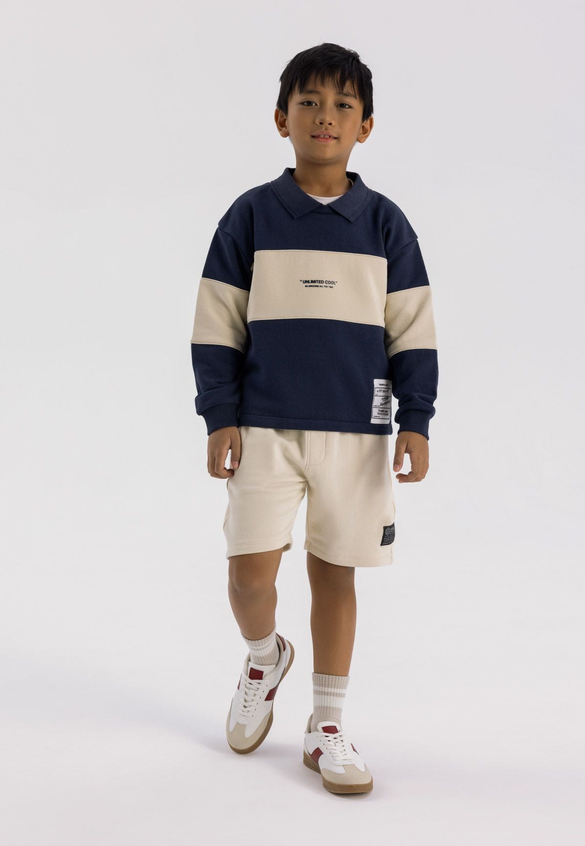 Navy and cream collared sweatshirt, model front.