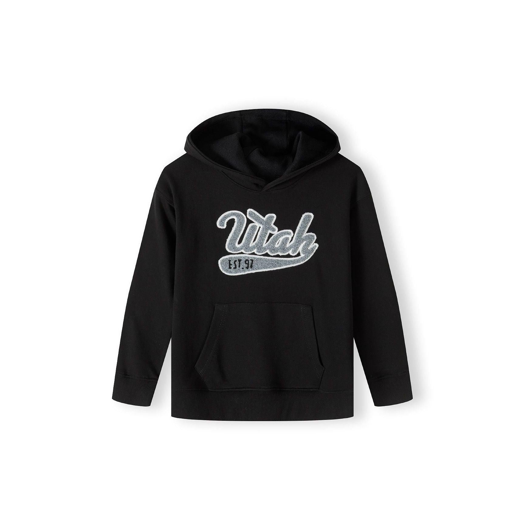 Back view of black oversized hoodie showing plain design and hood detail against white background
