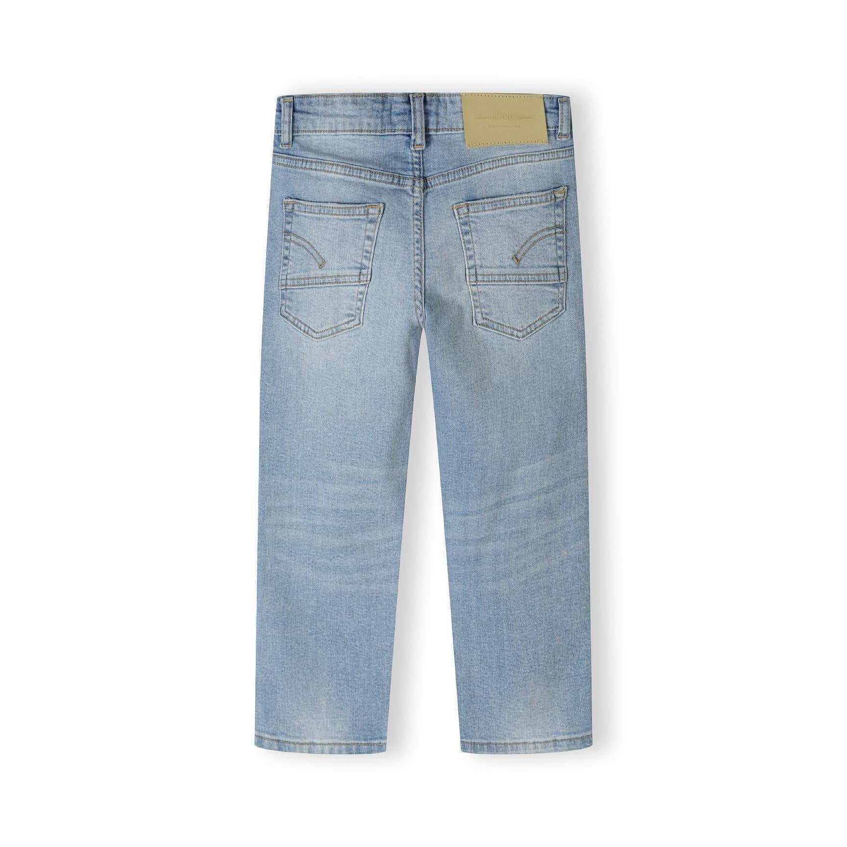 Back view of light blue denim jeans showing straight leg cut, back pockets, belt loops and yellow brand label on waistband