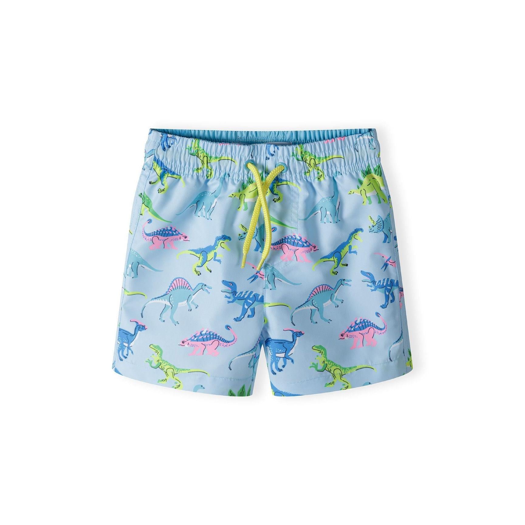 Light blue board shorts with colourful dinosaur print featuring green, pink and blue dinosaurs, elastic waistband with yellow drawstring, front view on white background
