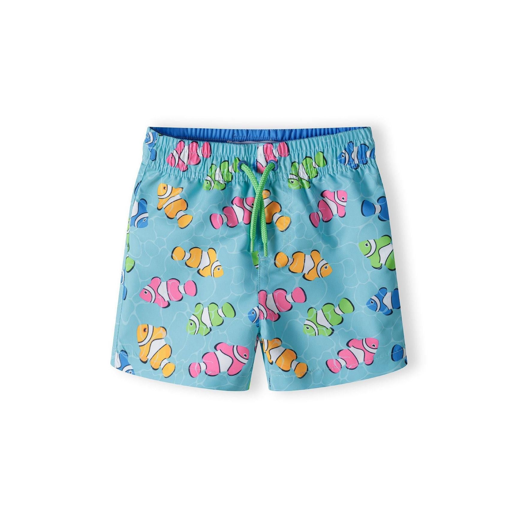 Turquoise board shorts with colourful clownfish print featuring orange, pink, green and blue fish scattered across the fabric, shown flat against white background