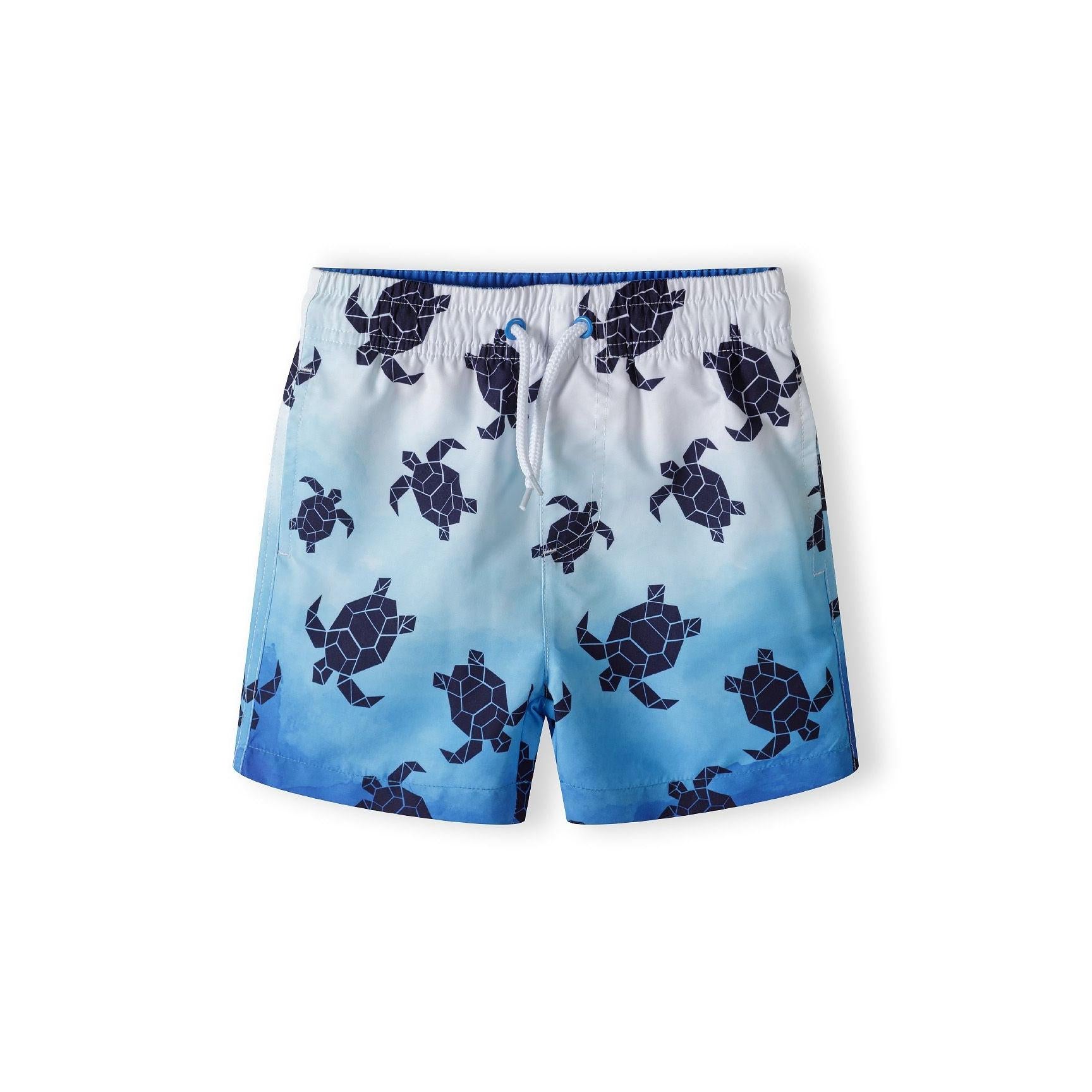 Light blue swim shorts with navy turtle print pattern and drawstring waistband shown flat against white background