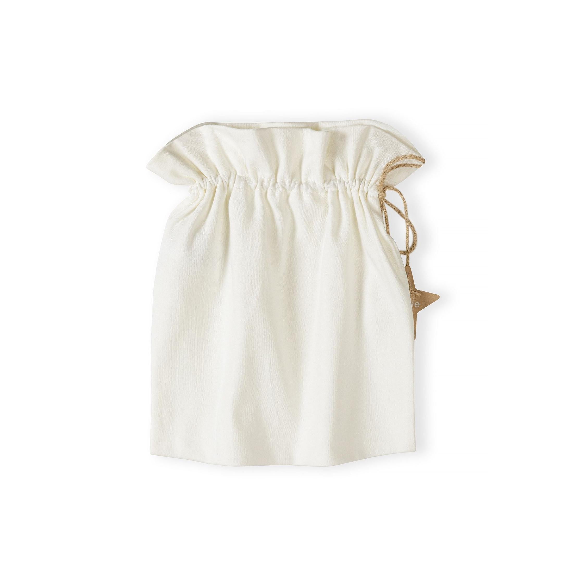 Cream cotton drawstring gift bag with natural cord ties and small wooden star charm on white background