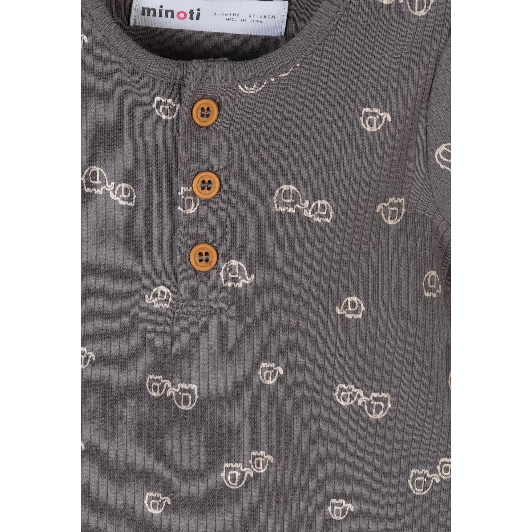 Close-up detail of grey romper showing Minoti label, wooden buttons, elephant print pattern and ribbed cotton texture