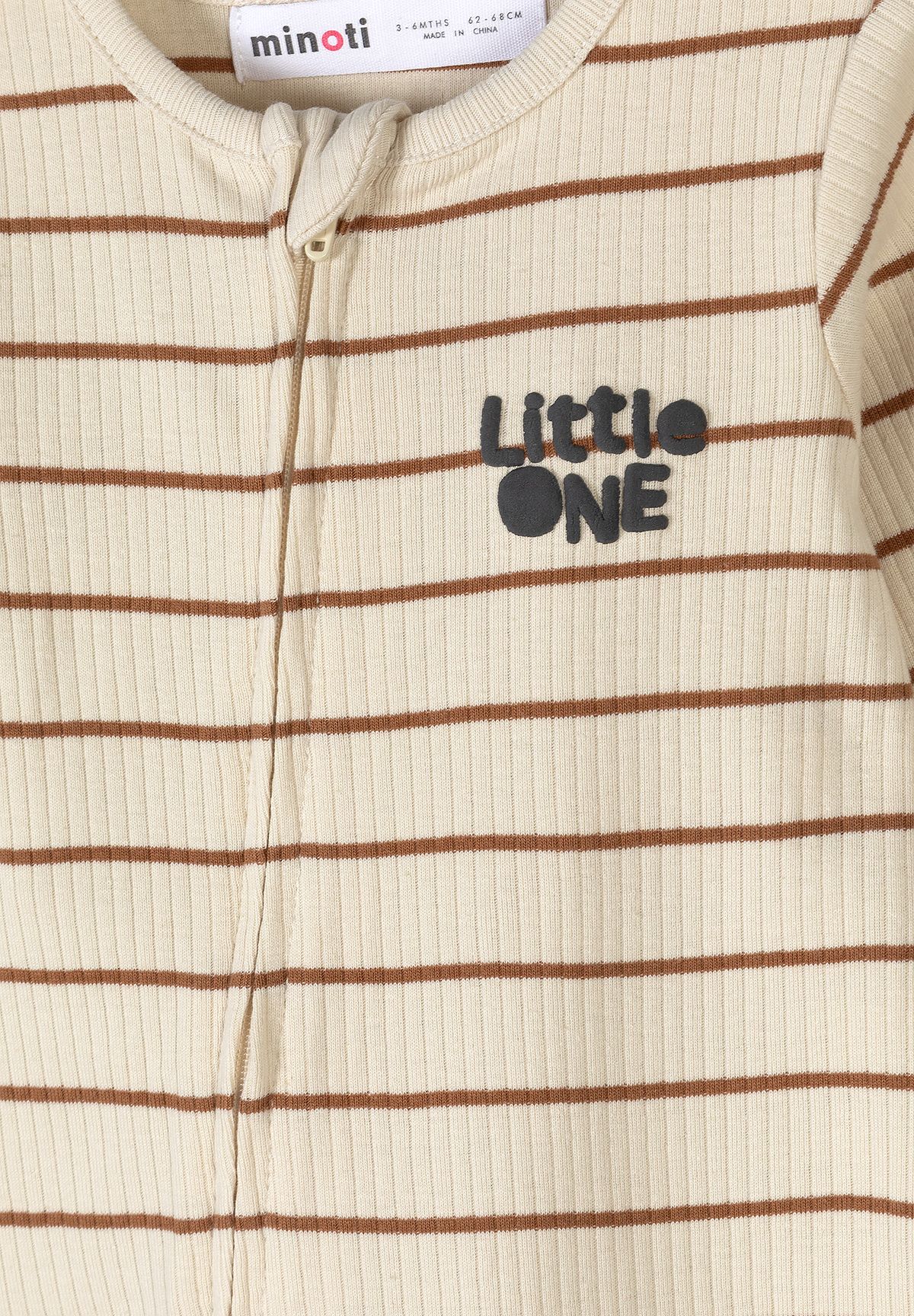 Close-up of striped baby sleepsuit's zip, ribbing and LITTLE ONE print.
