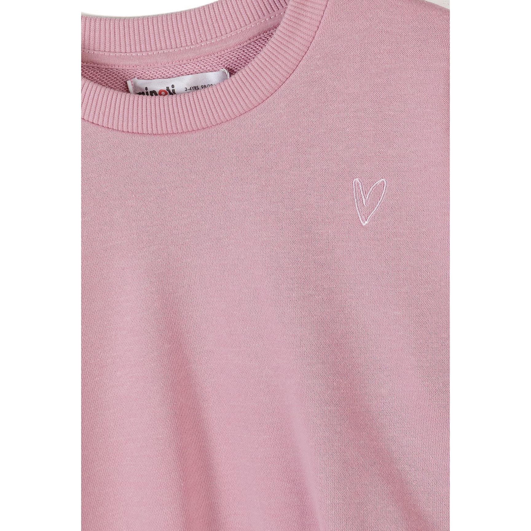 Close-up detail of blue crew neck sweatshirt showing Minoti label and small embroidered heart design on chest area