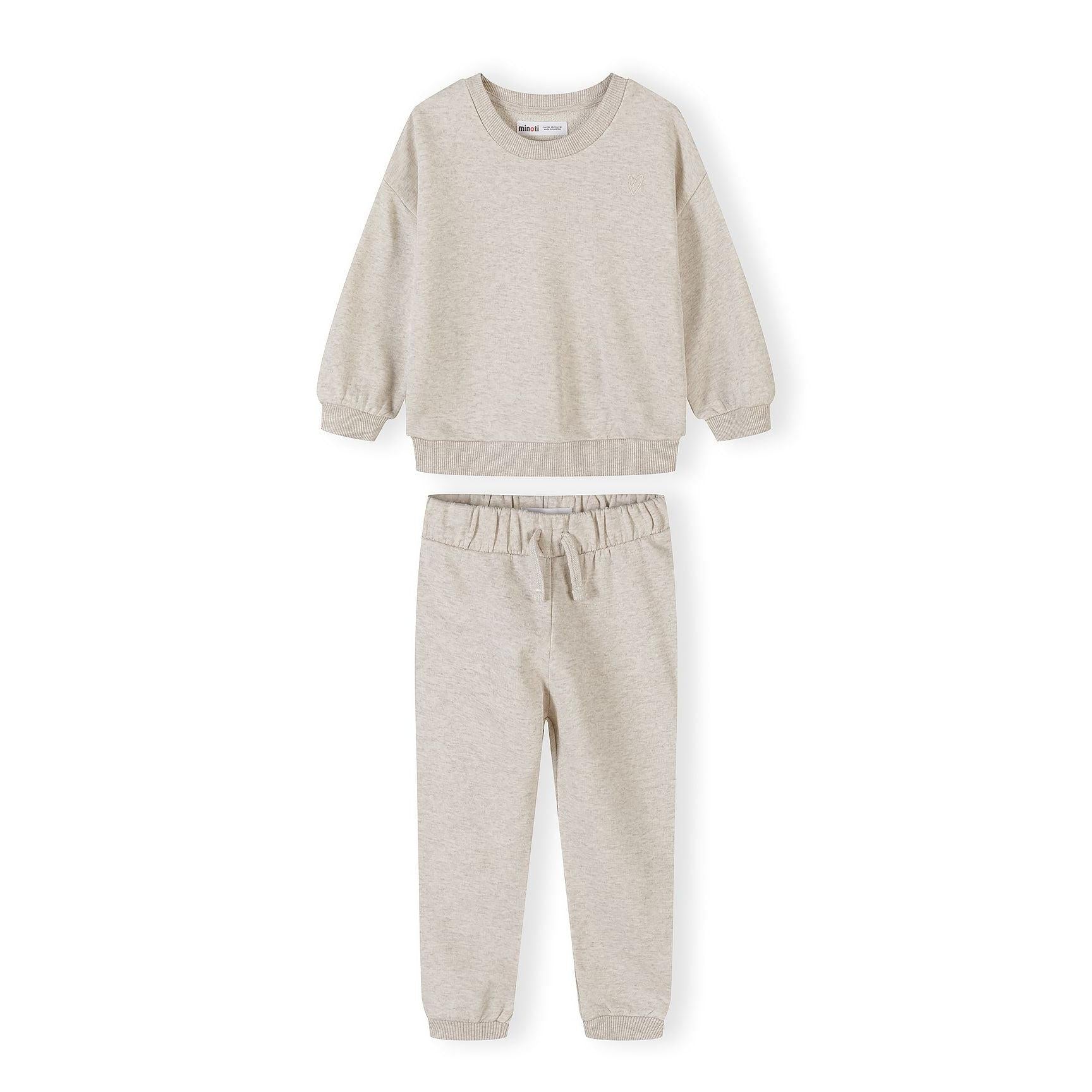 Cream tracksuit set with sweatshirt and joggers laid flat showing ribbed details and elastic waistband on white background