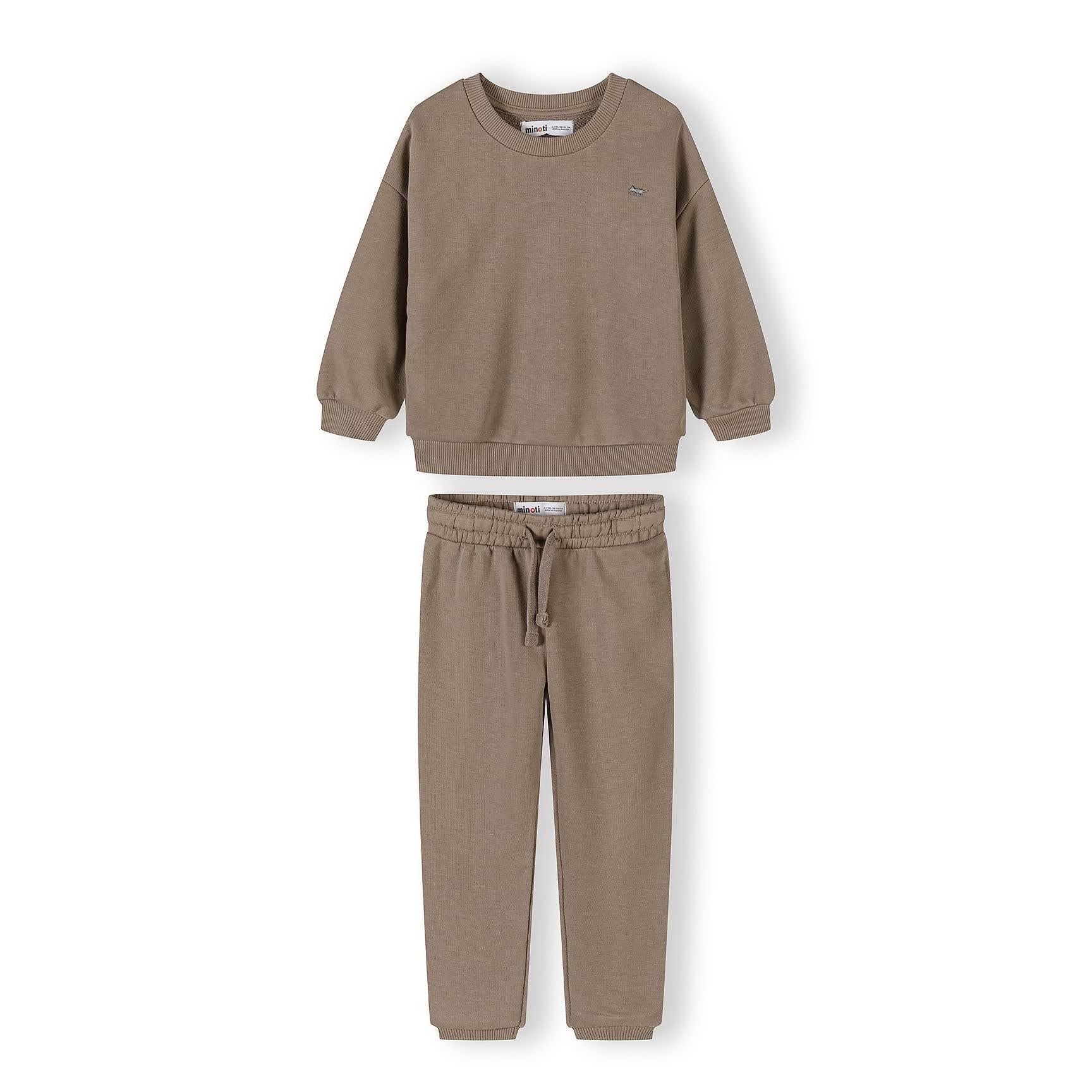 Close-up of cream tracksuit set showing sweatshirt with crew neckline and matching joggers with elasticated waist on white background