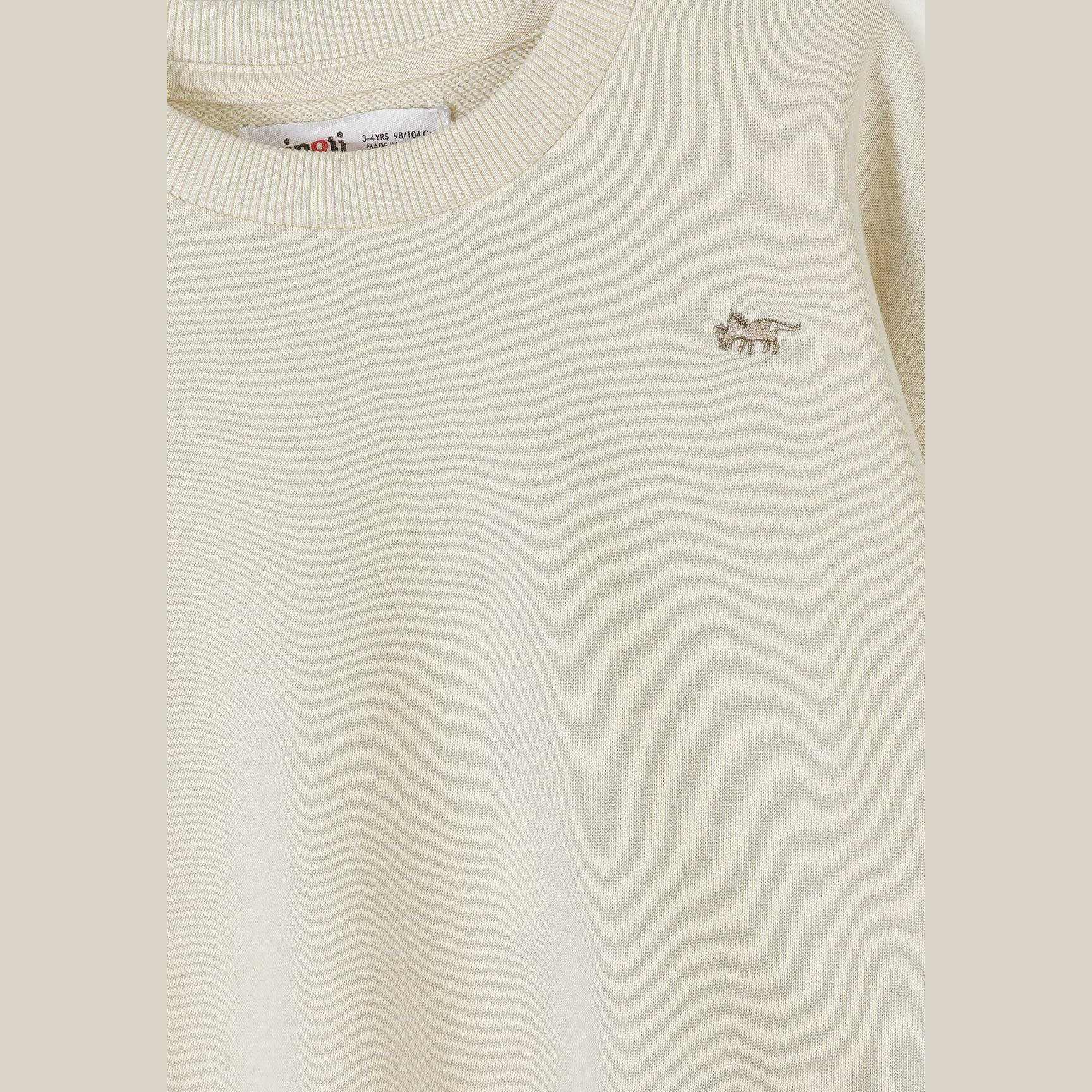 Detail shot of beige sweatshirt showing Minoti label at neckline and small embroidered logo on chest area