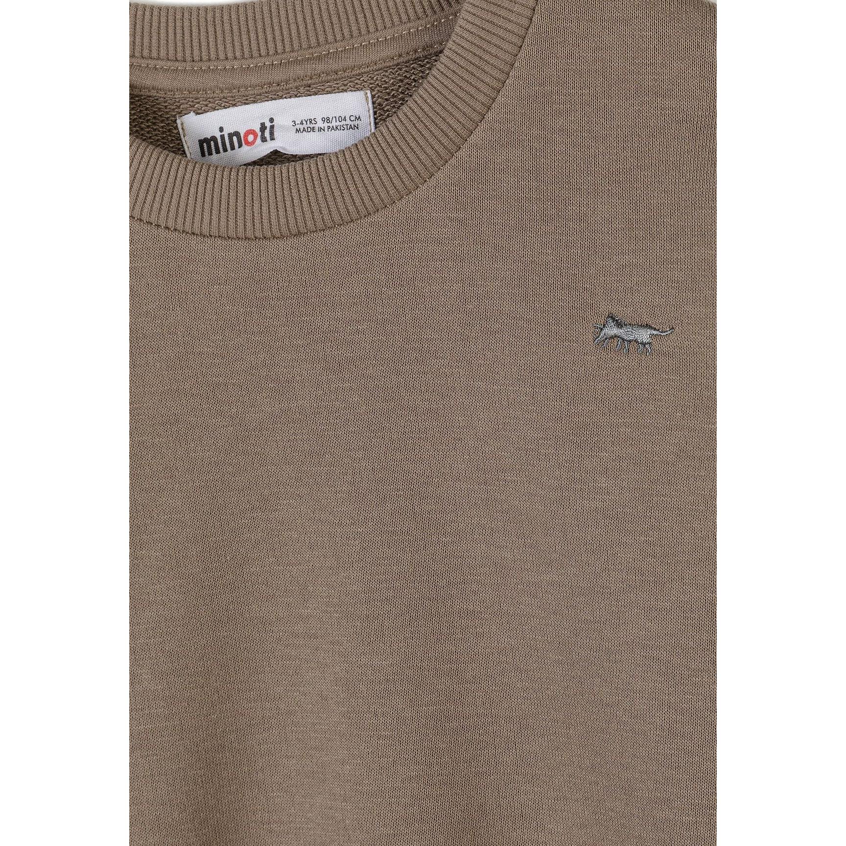 Detail shot of beige sweatshirt showing Minoti label at neckline and small embroidered logo on chest area
