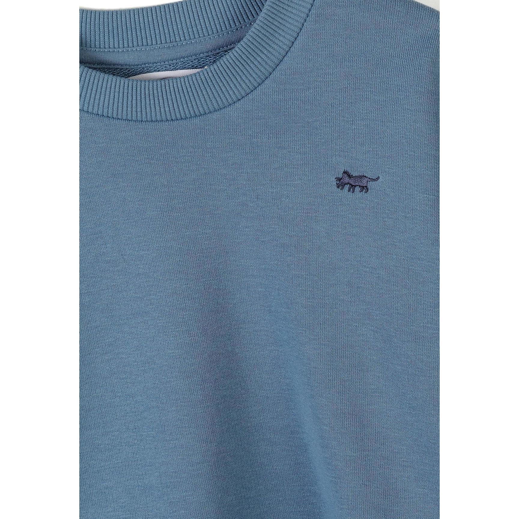 Close-up detail of gunmetal sweatshirt showing Minoti label and small embroidered animal logo on chest