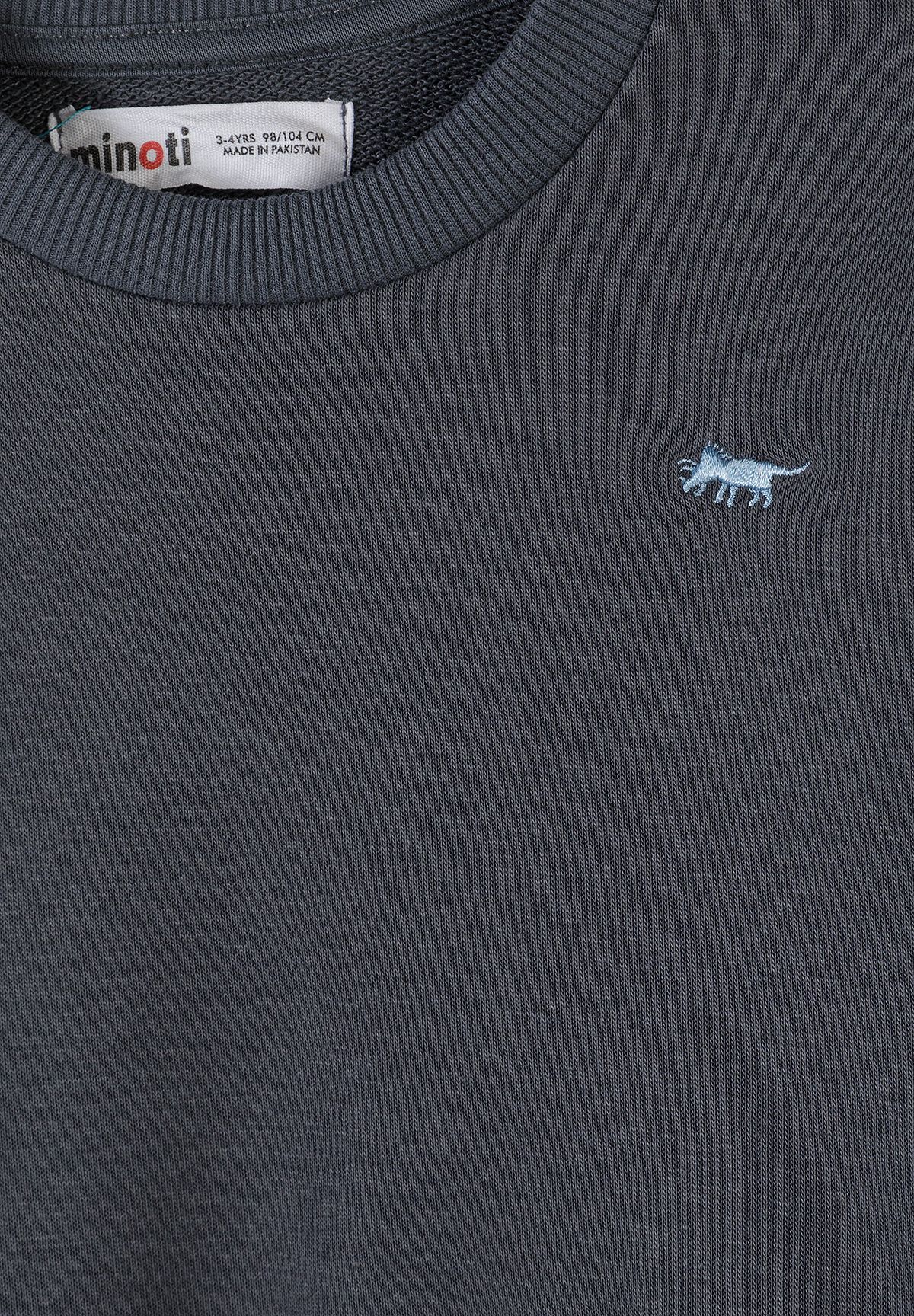 Close-up of the charcoal sweatshirt's pale blue animal embroidery and ribbed collar.