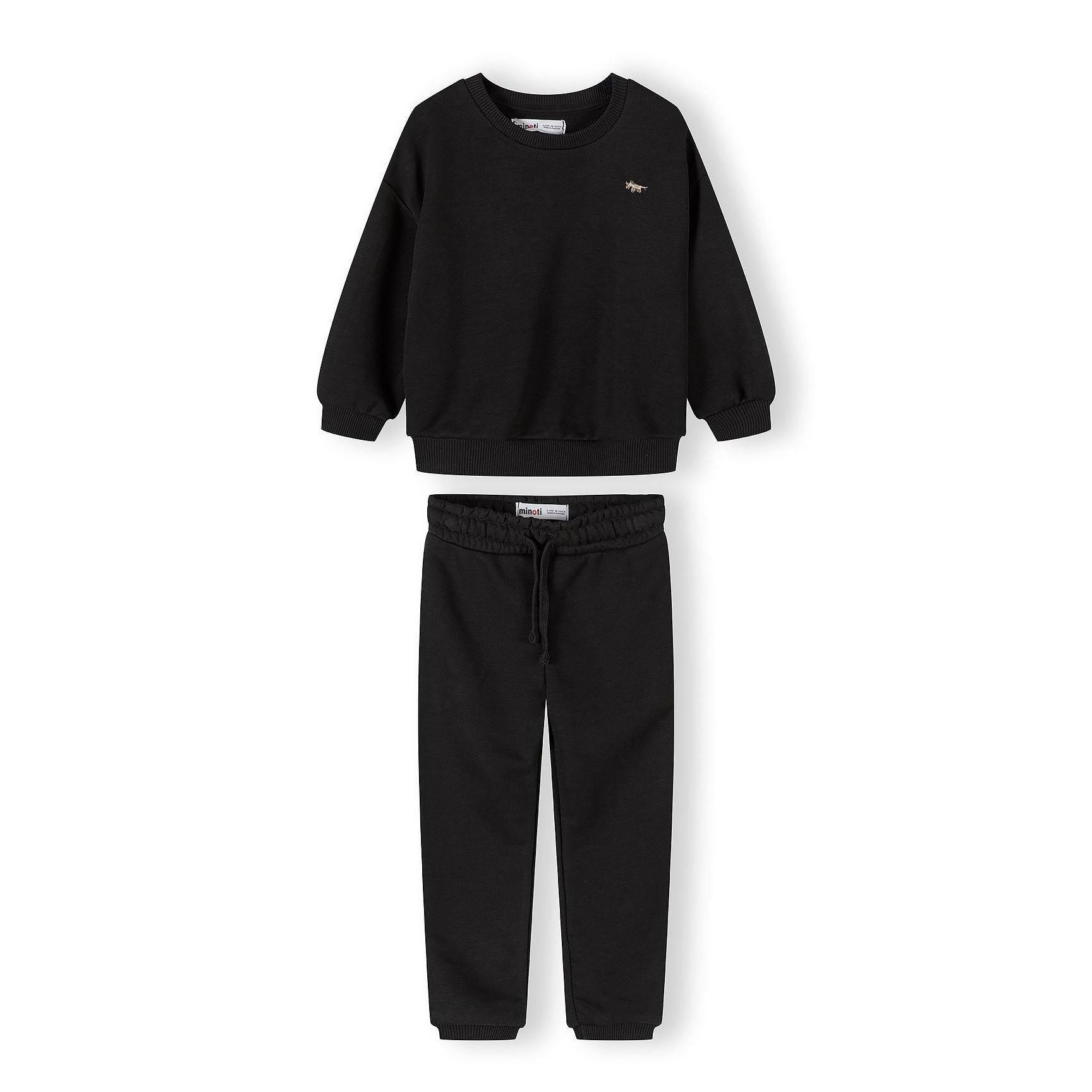 Black tracksuit set with sweatshirt and joggers laid flat showing classic sporty styling on white background