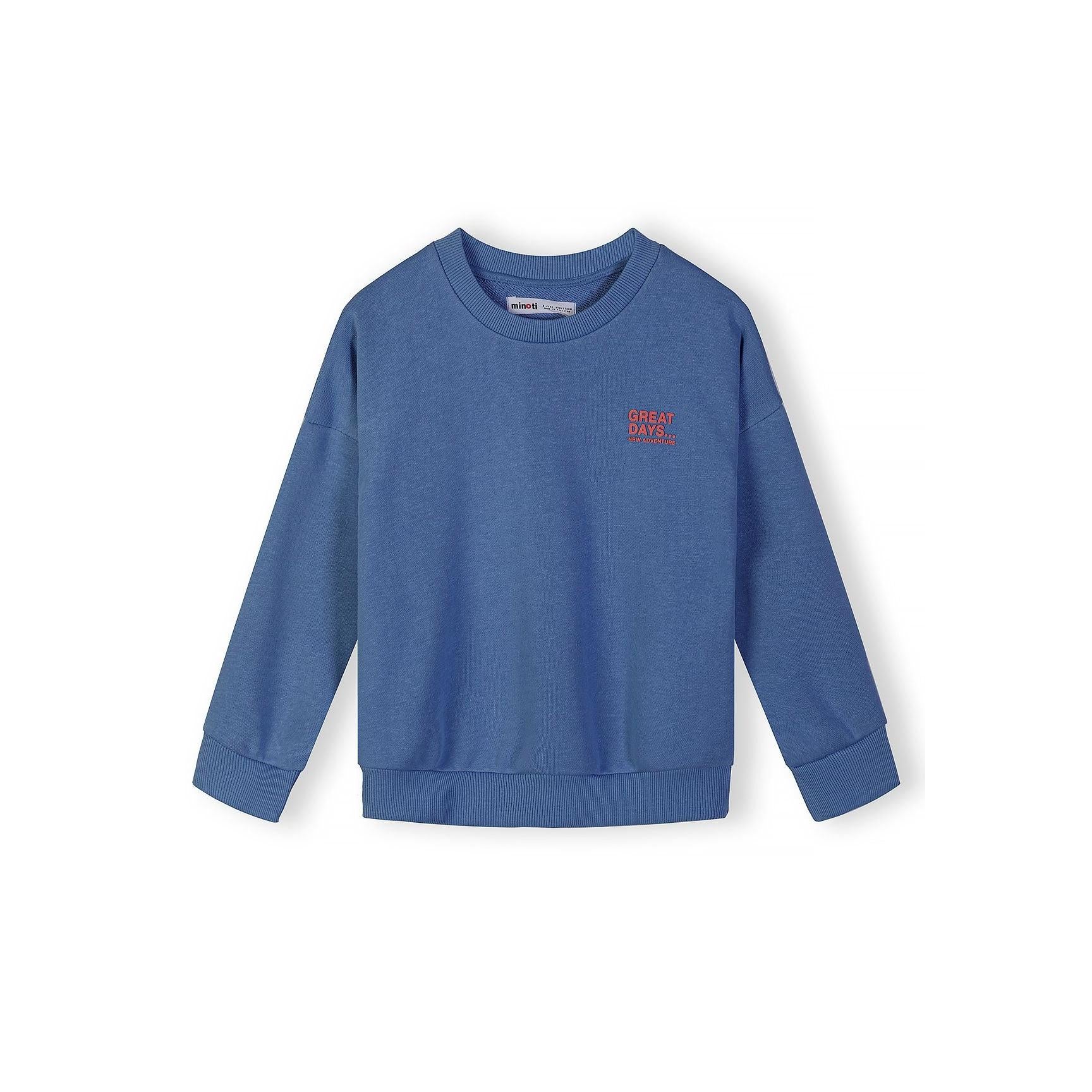 Close-up detail of blue sweatshirt showing Minoti brand label and red 'GREAT DAYS... NEW ADVENTURES' chest print on cotton fabric