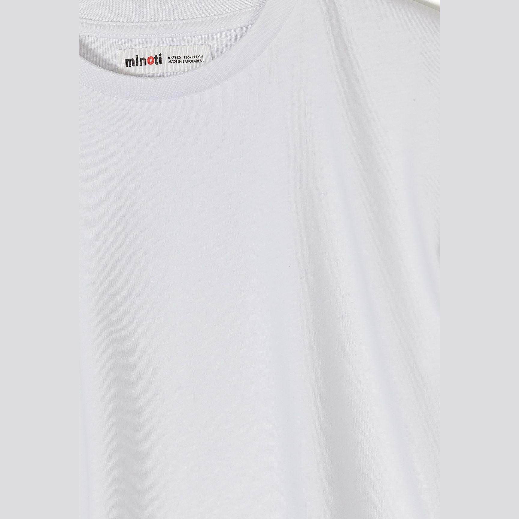 Close-up detail shot of white ribbed cotton t-shirt showing neck area and Minoti brand label with sizing information clearly visible