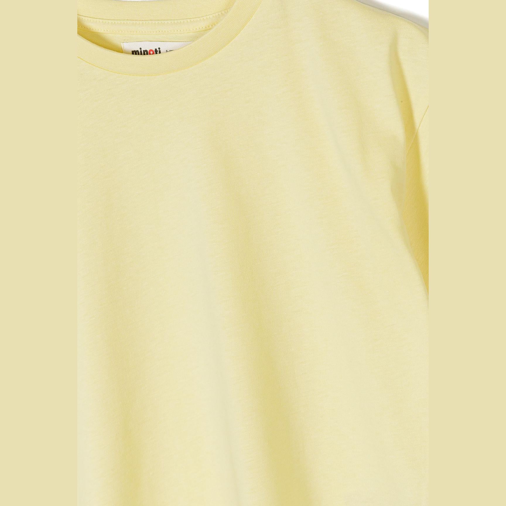 Close-up detail of yellow t-shirt showing soft cotton texture, crew neck construction and Minoti brand label at neckline