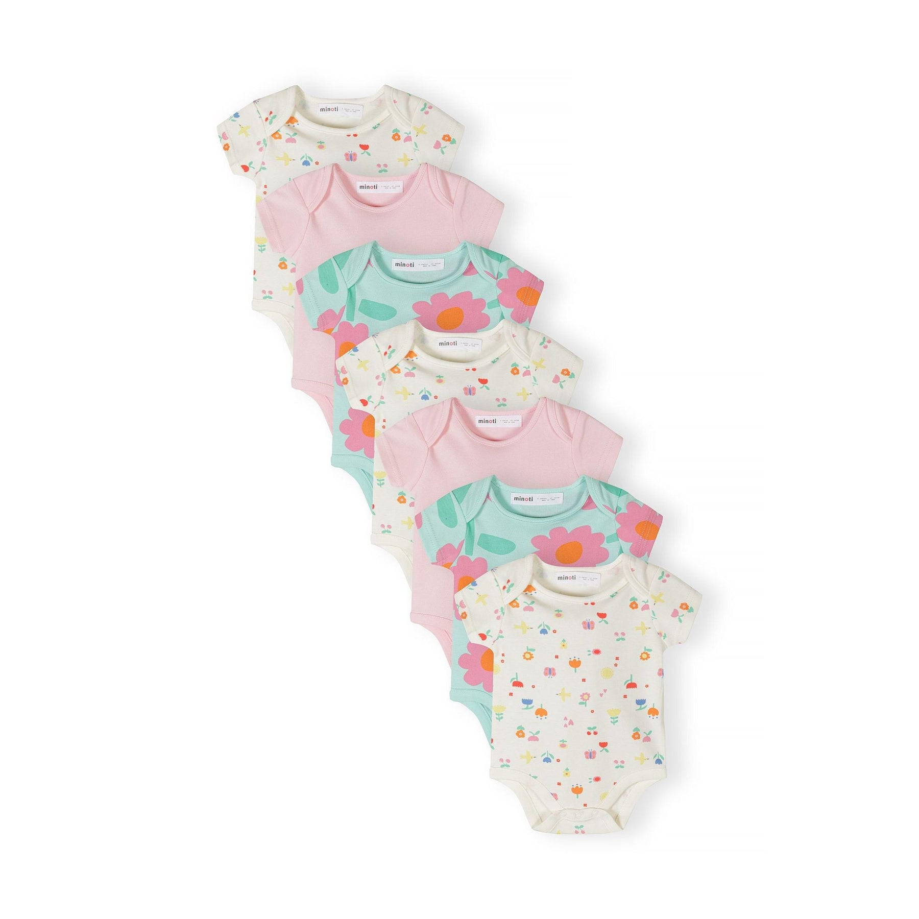 Seven baby bodysuits arranged in overlapping display showing mint floral prints, pink solids and cream with small motifs on white background