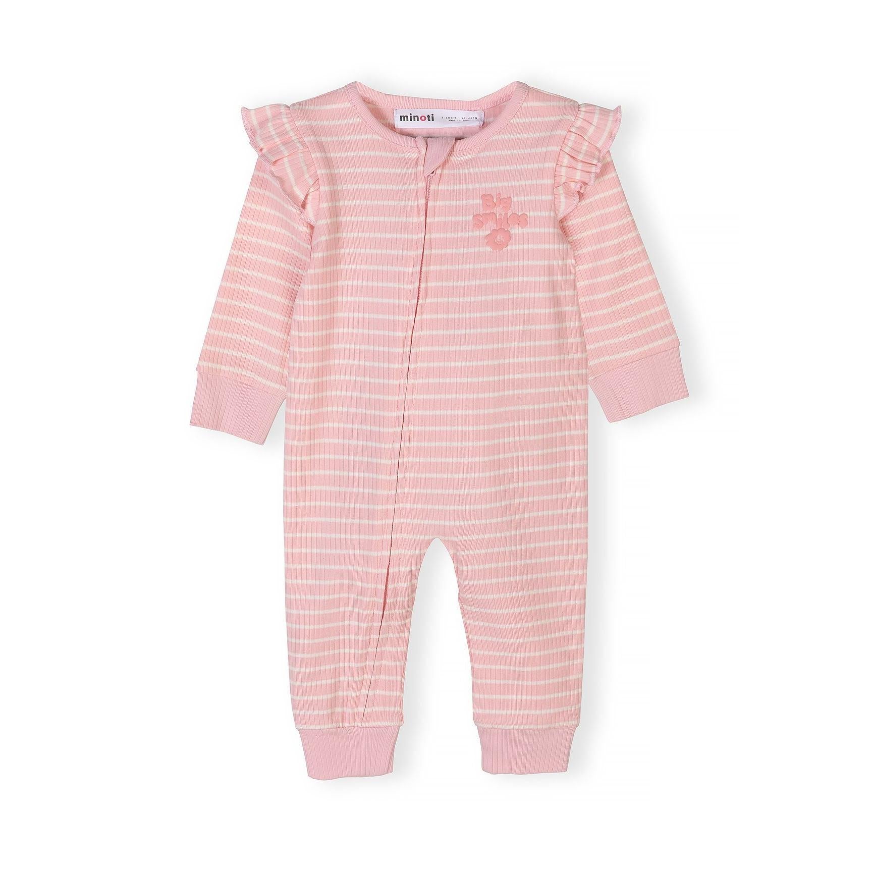 Close-up of cream sleepsuit with all-over bunny and bow print pattern showing ribbed texture
