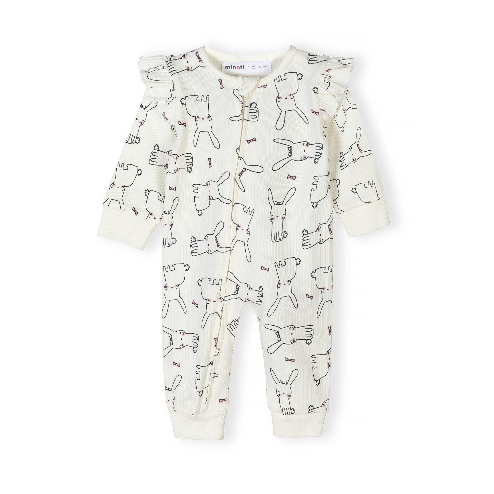 Close-up of cream sleepsuit with all-over bunny and bow print pattern showing ribbed texture