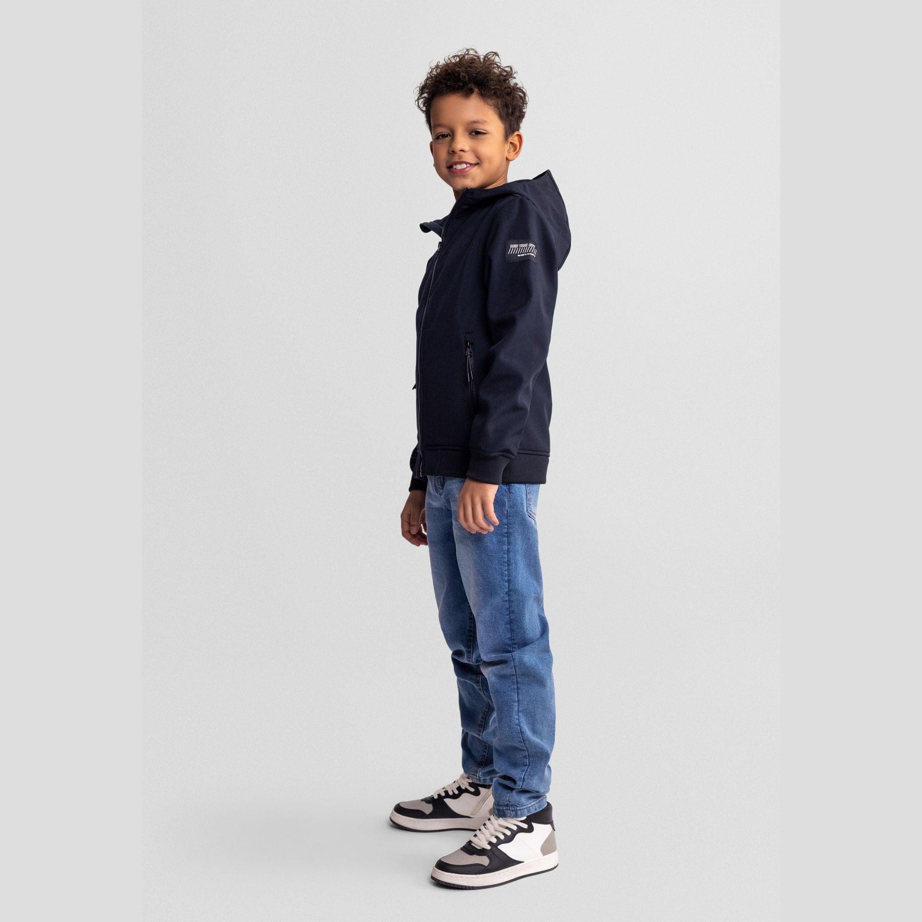 Black softshell jacket displayed flat against white background showing full zip front, hood and side pockets