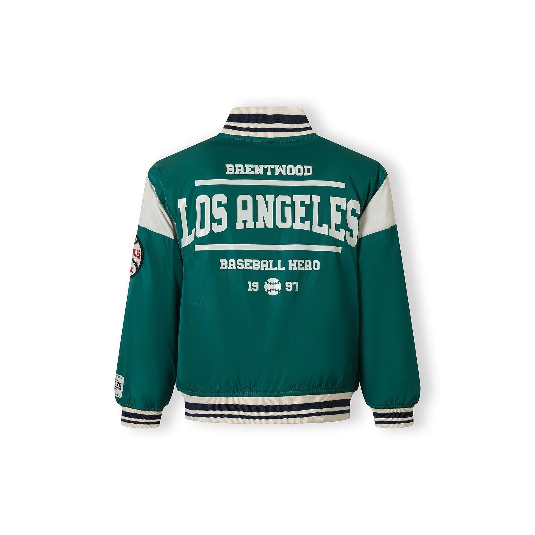 Close-up detail of green bomber jacket showing side pocket and partial LA patch with navy and cream lettering