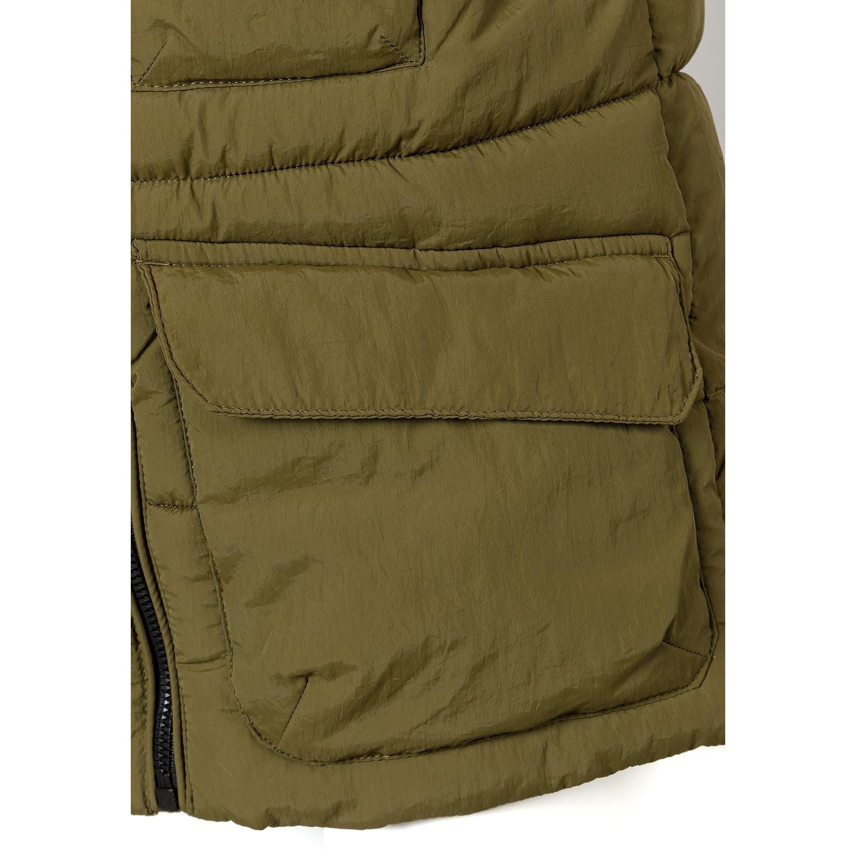 Close-up detail of olive waistcoat showing front zip, flap pocket and quilted padding texture