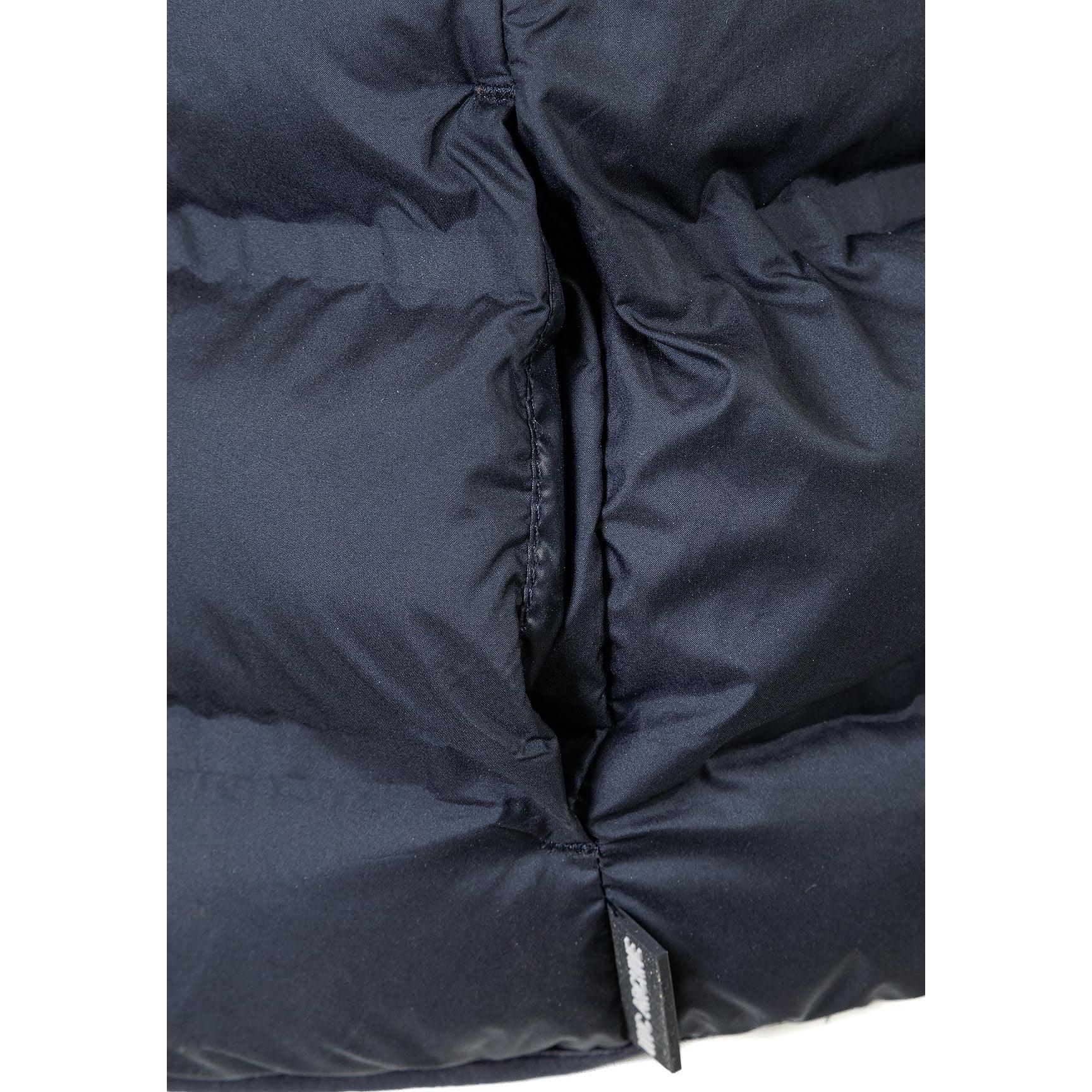 Close-up detail of navy blue padded gilet showing quilted texture, zip closure and fabric construction