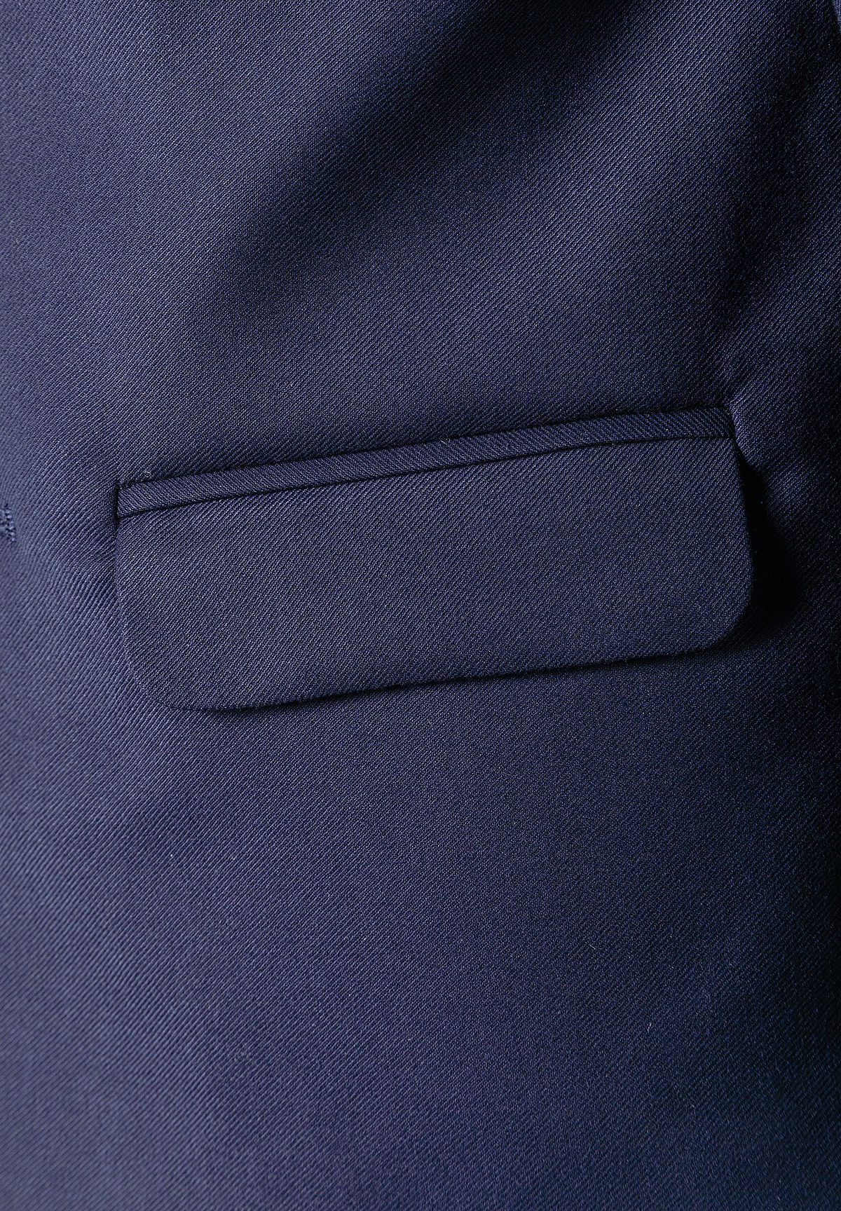 Close-up of navy blazer flap pocket and woven fabric texture.