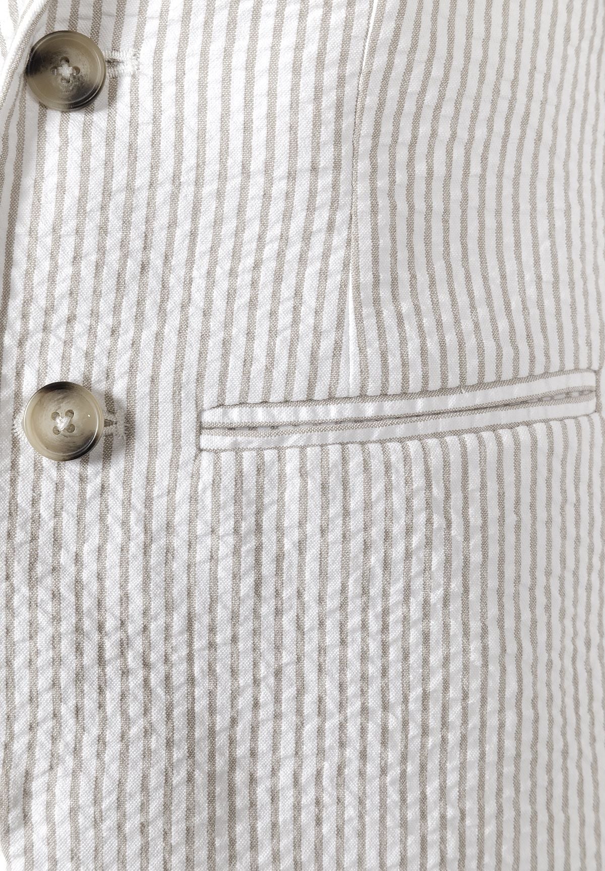 Detail of a boys' stone striped blazer with front button and side pocket.