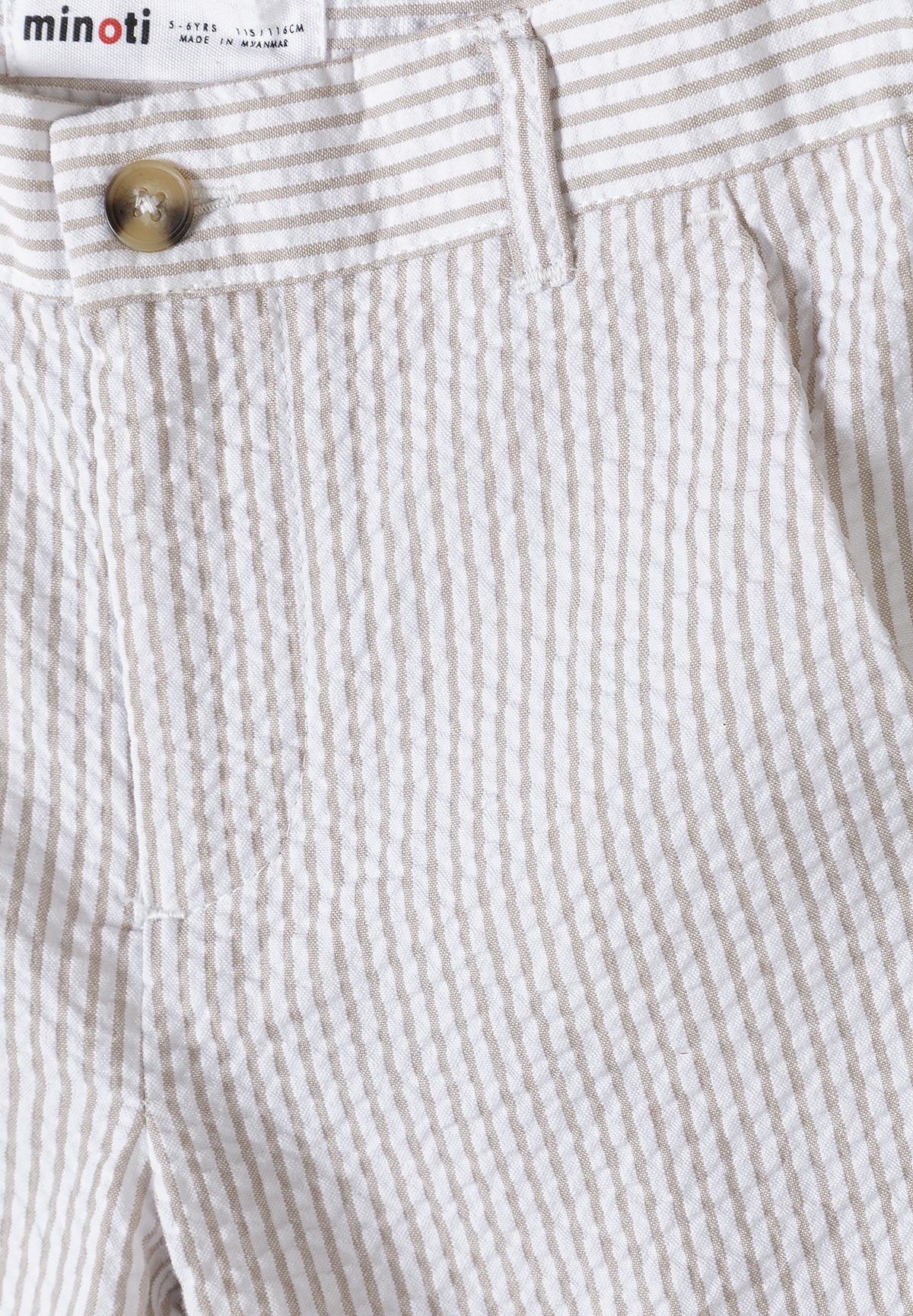 Close-up of stone and white pinstriped shorts' waist button, belt loop and side pocket.