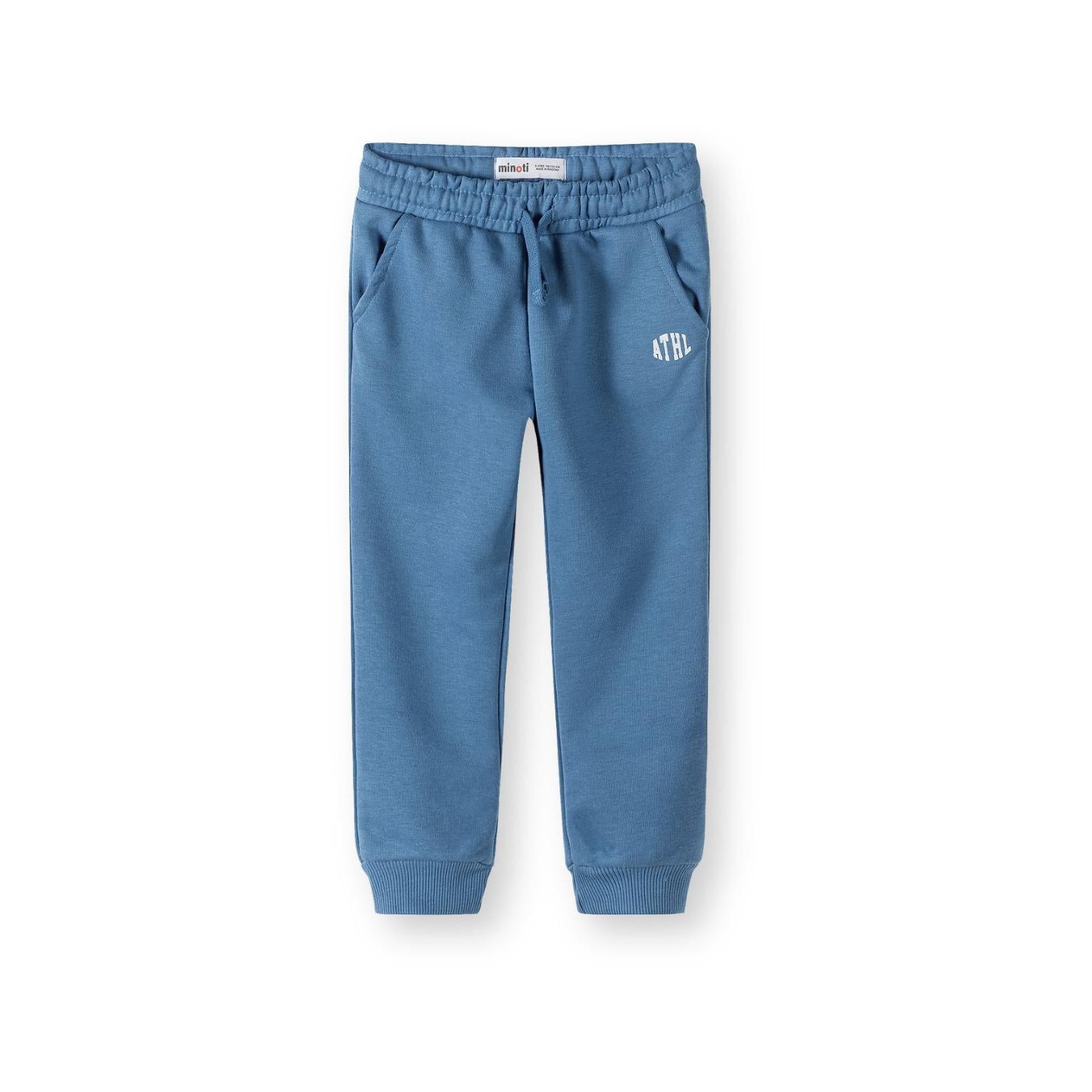 Close-up detail of blue joggers showing elastic waistband with drawstring, side pocket and white ATHL logo with Minoti brand label