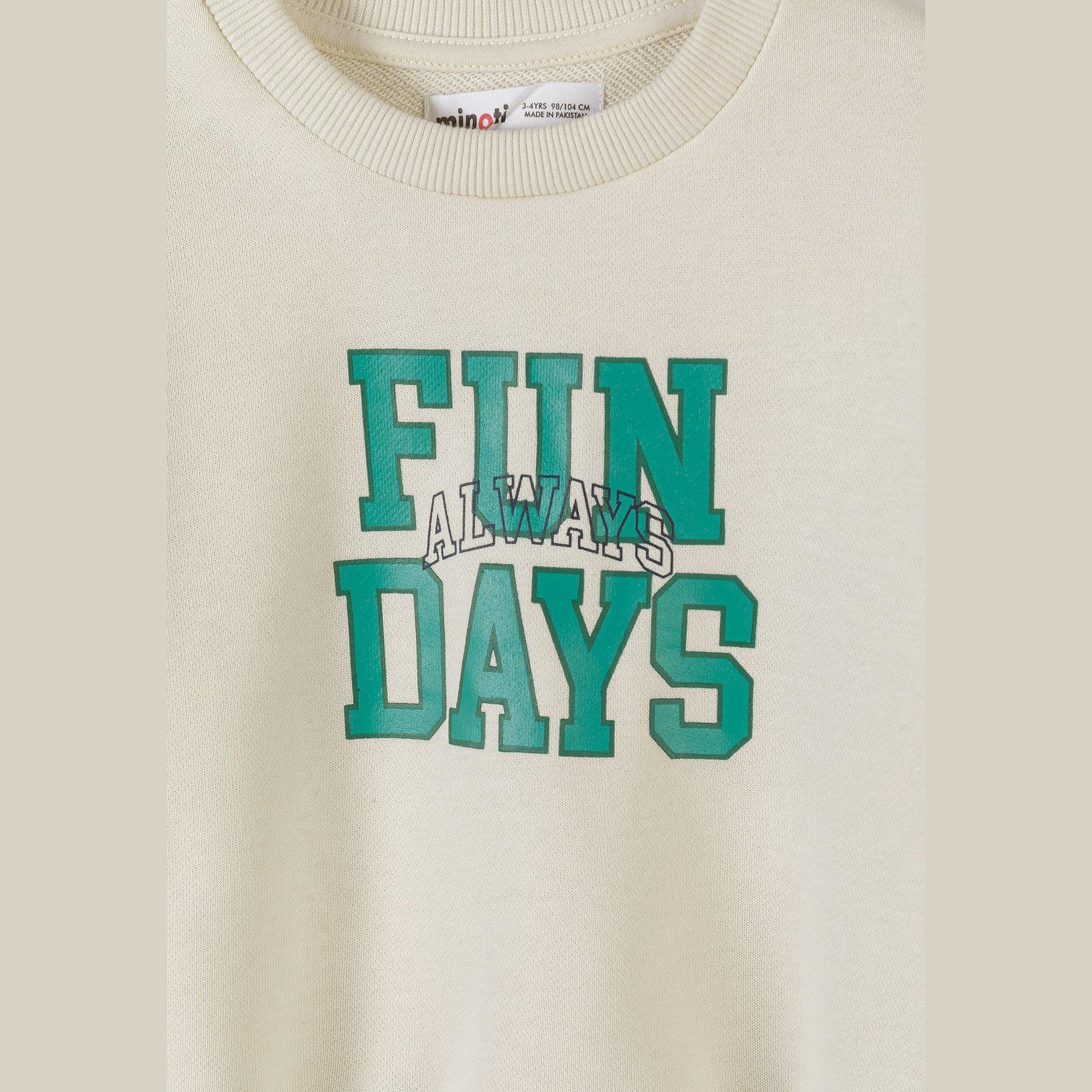 Detail view of cream sweatshirt featuring Fun Days text with Always script overlay and Minoti brand label visible at neckline