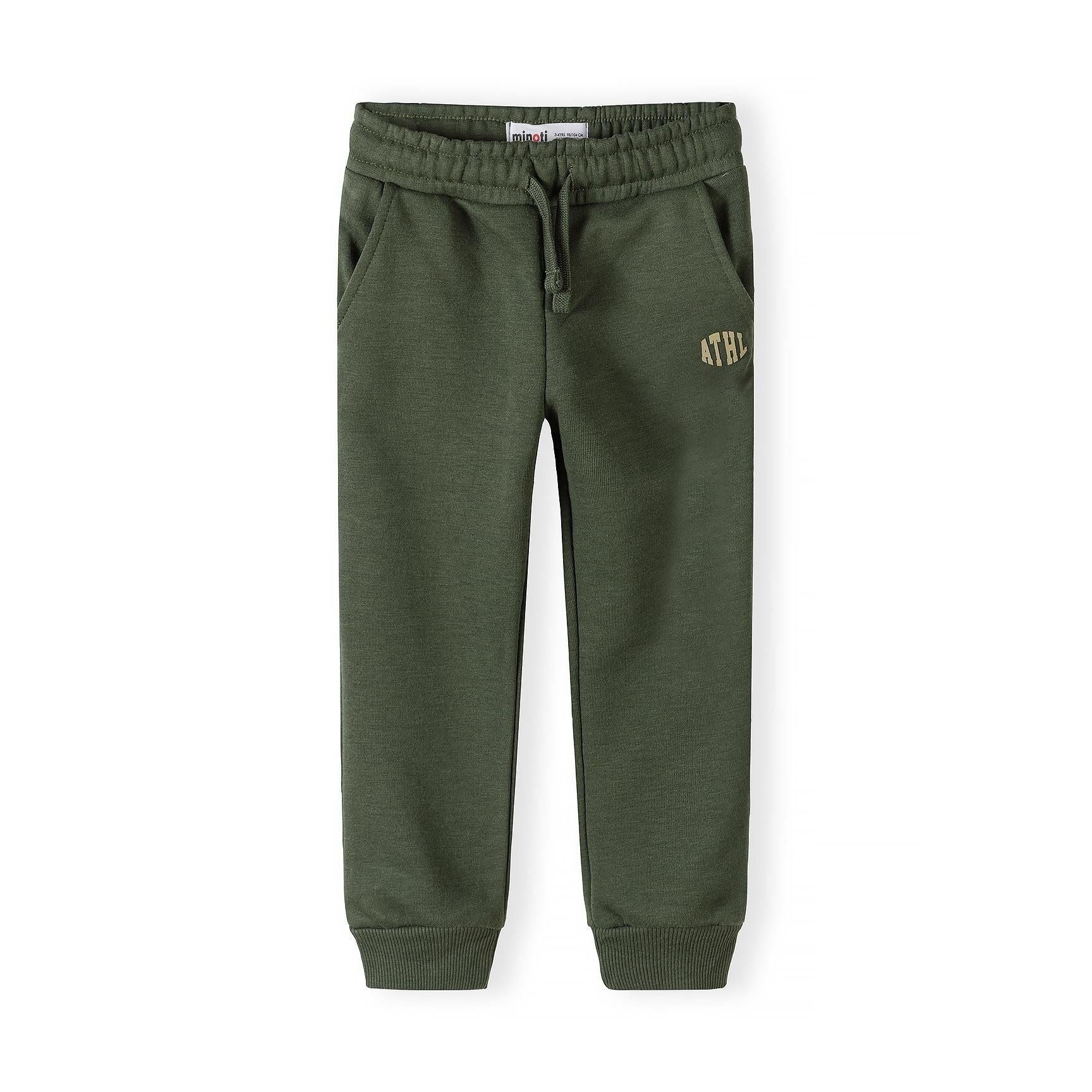 Close-up detail of black joggers showing Minoti label, drawstring elastic waistband and white ATHL lettering on the leg