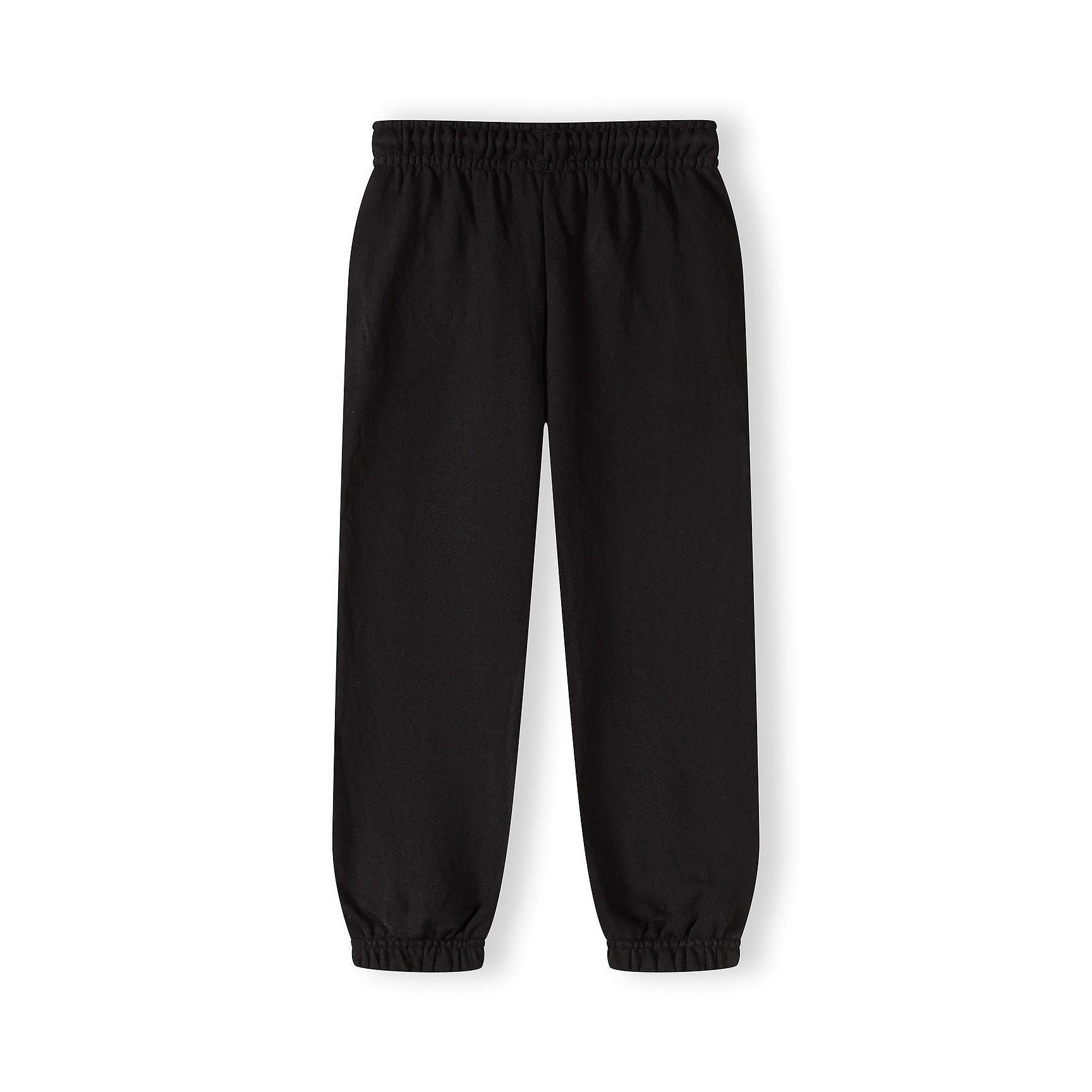 Close-up detail of black joggers showing elastic waistband with drawstring and circular printed text design featuring Japanese characters
