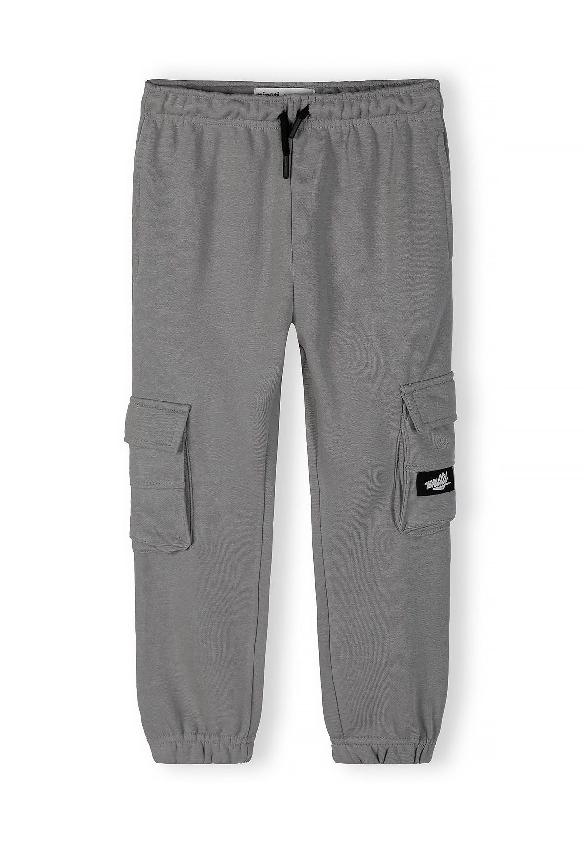 Boys grey jogging pants with elastic waistband and cargo pockets, front view.