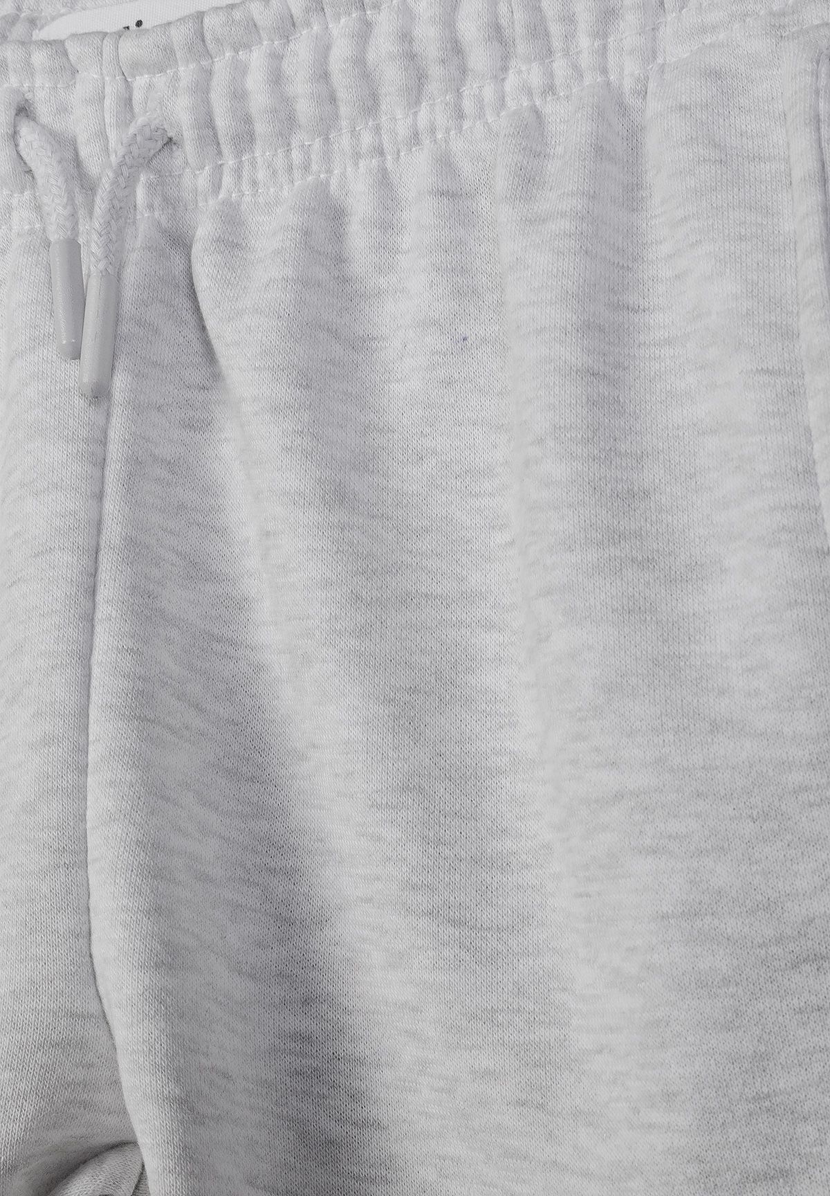 Close-up of light-grey-marl joggers showing gathered waistband, drawstring and slanted hip pocket.
