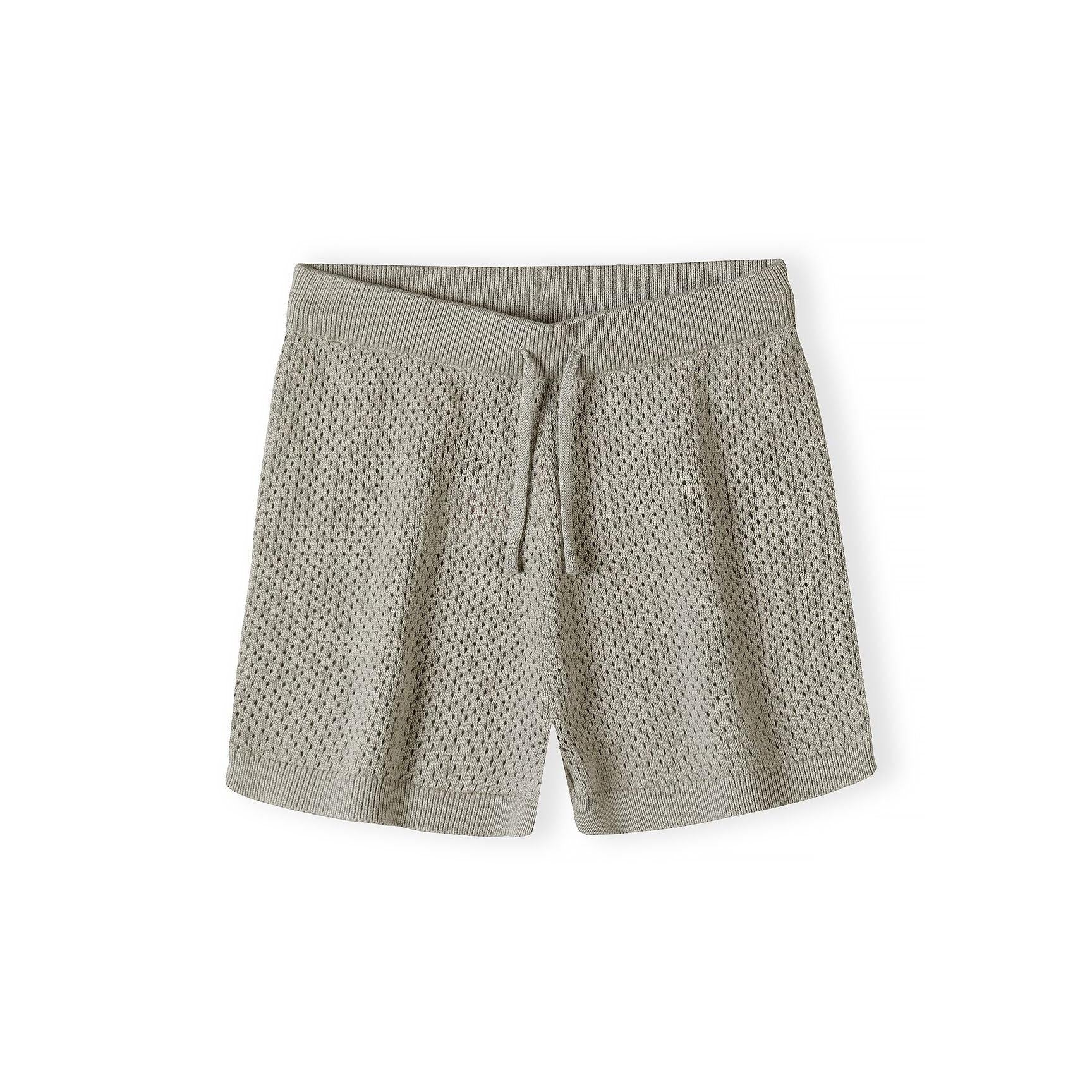 Close-up detail of khaki knitted shorts waistband showing textured mesh pattern fabric and drawstring tie on white background