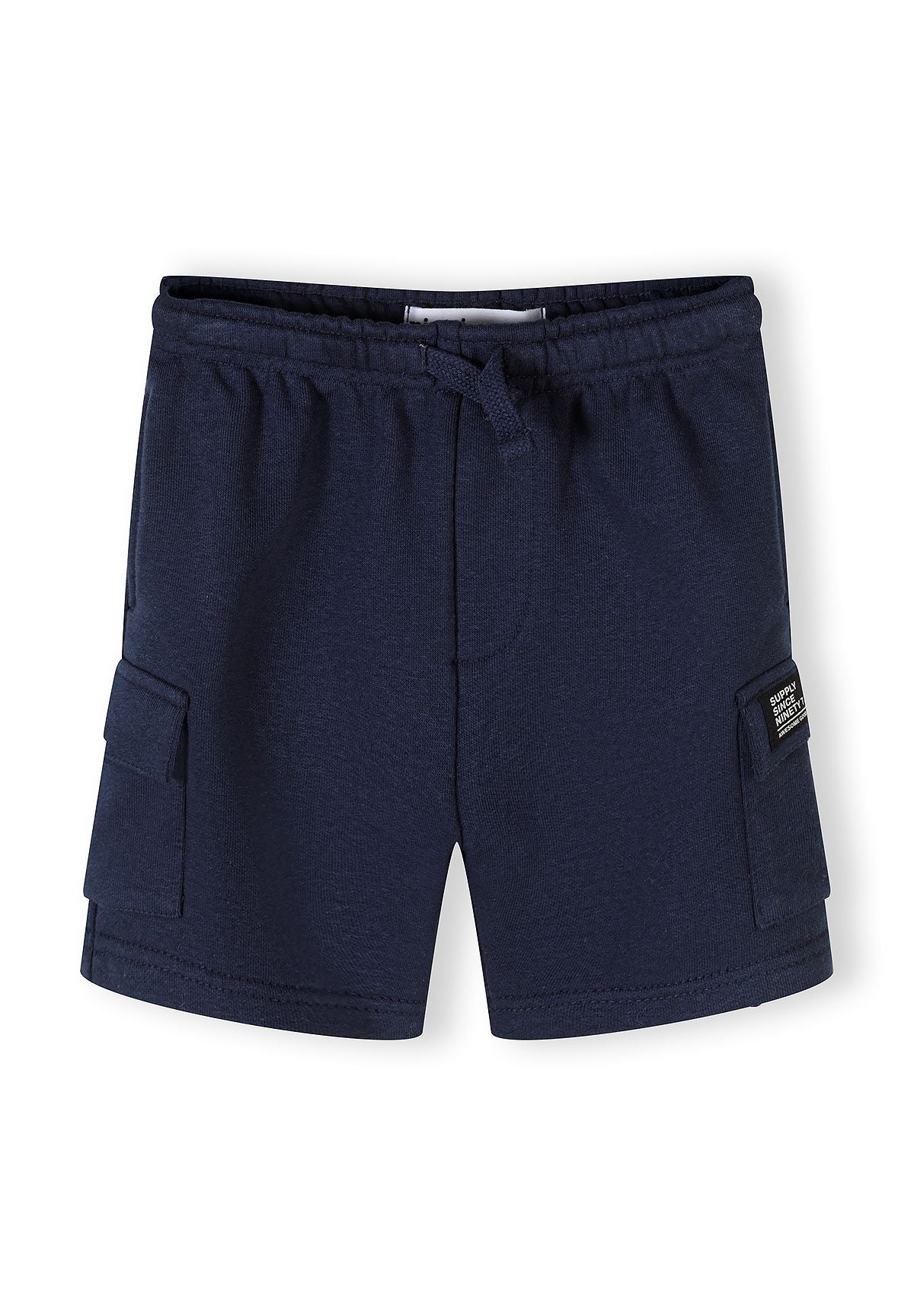 Detail of navy blue shorts with elasticated waistband and side pockets.