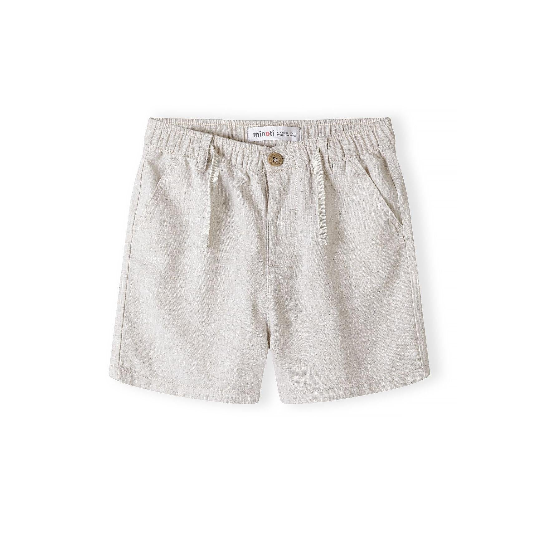 Close-up detail of light blue knitted polo shirt showing Minoti label, three wooden buttons on placket and white collar trim