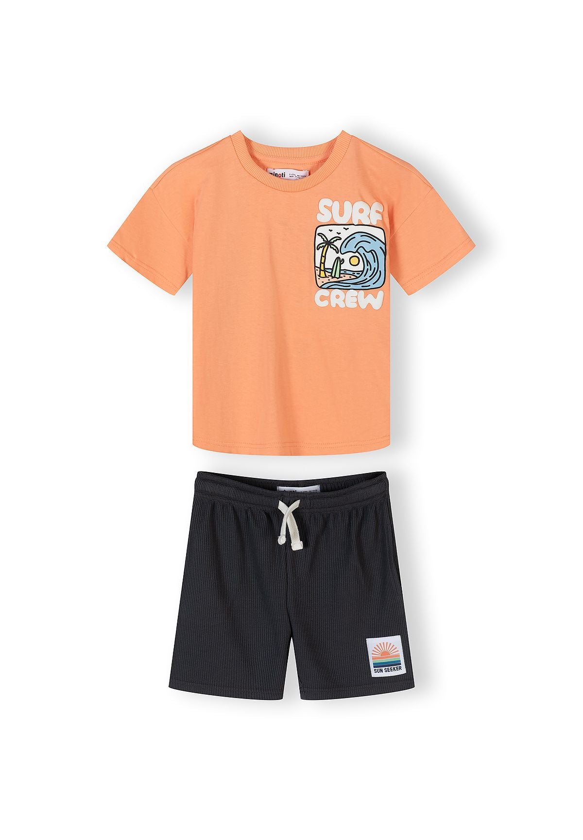 Boys short-sleeved cotton t-shirt in apricot with graphic and matching waffle shorts in dark gray, front view.