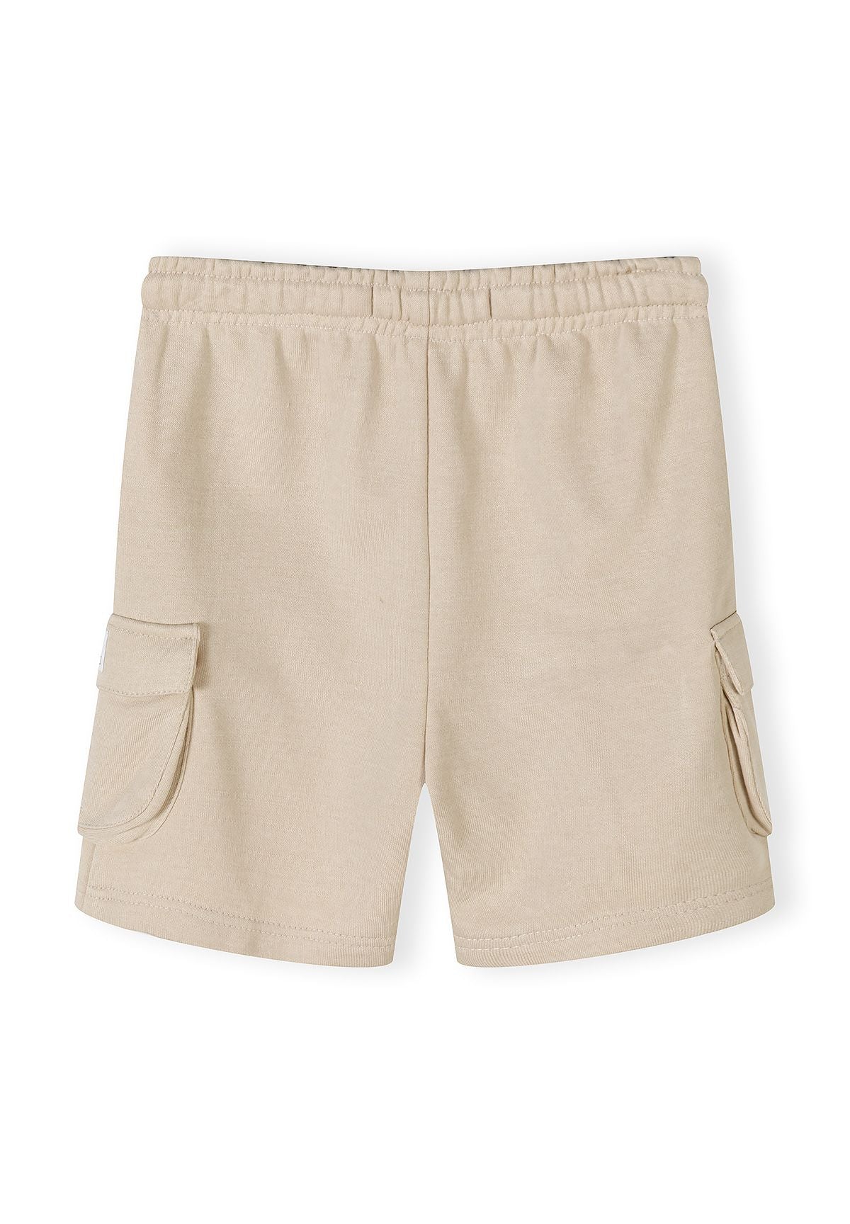 Detail of beige combat shorts with elasticated waistband and cargo pockets.