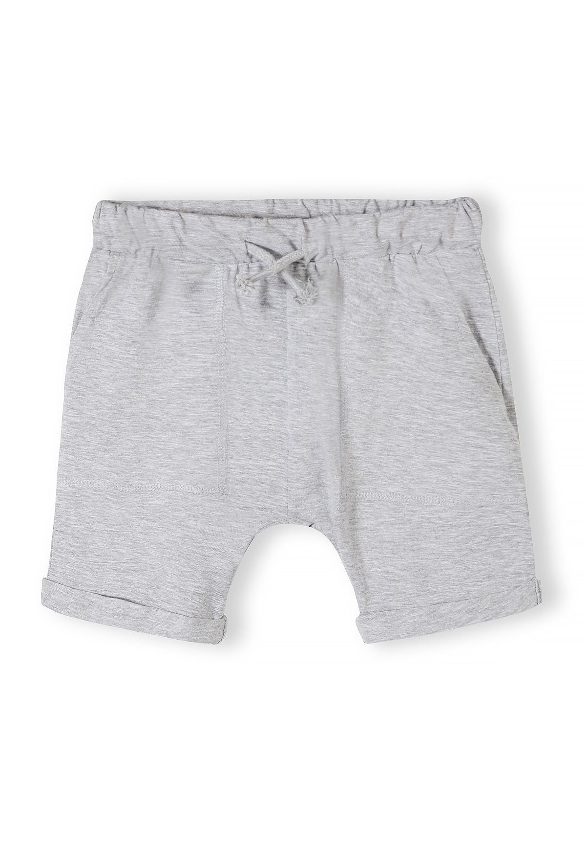 Detail of grey cotton shorts with elastic waistband and side pockets.