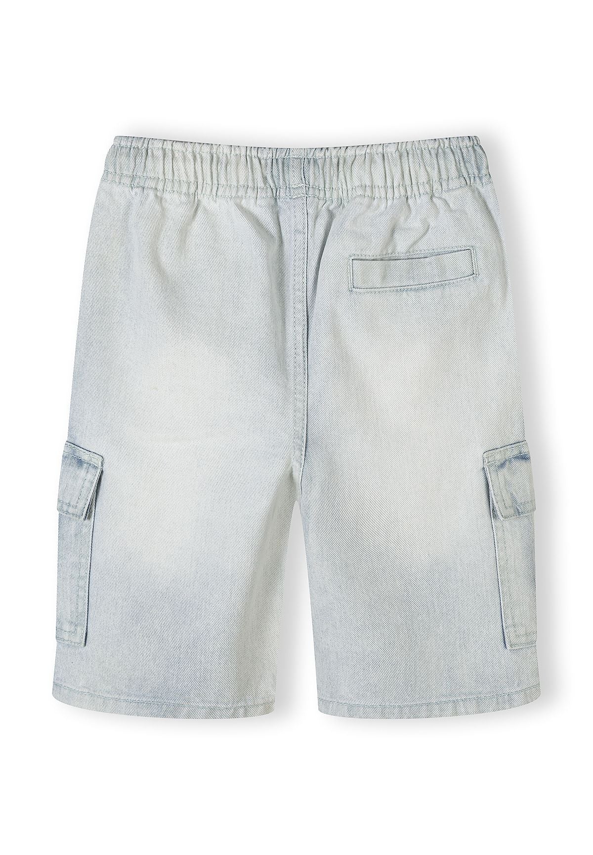 Close-up detail of light blue denim cargo shorts showing Minoti label, elastic waistband with rope drawstring and cargo pocket construction