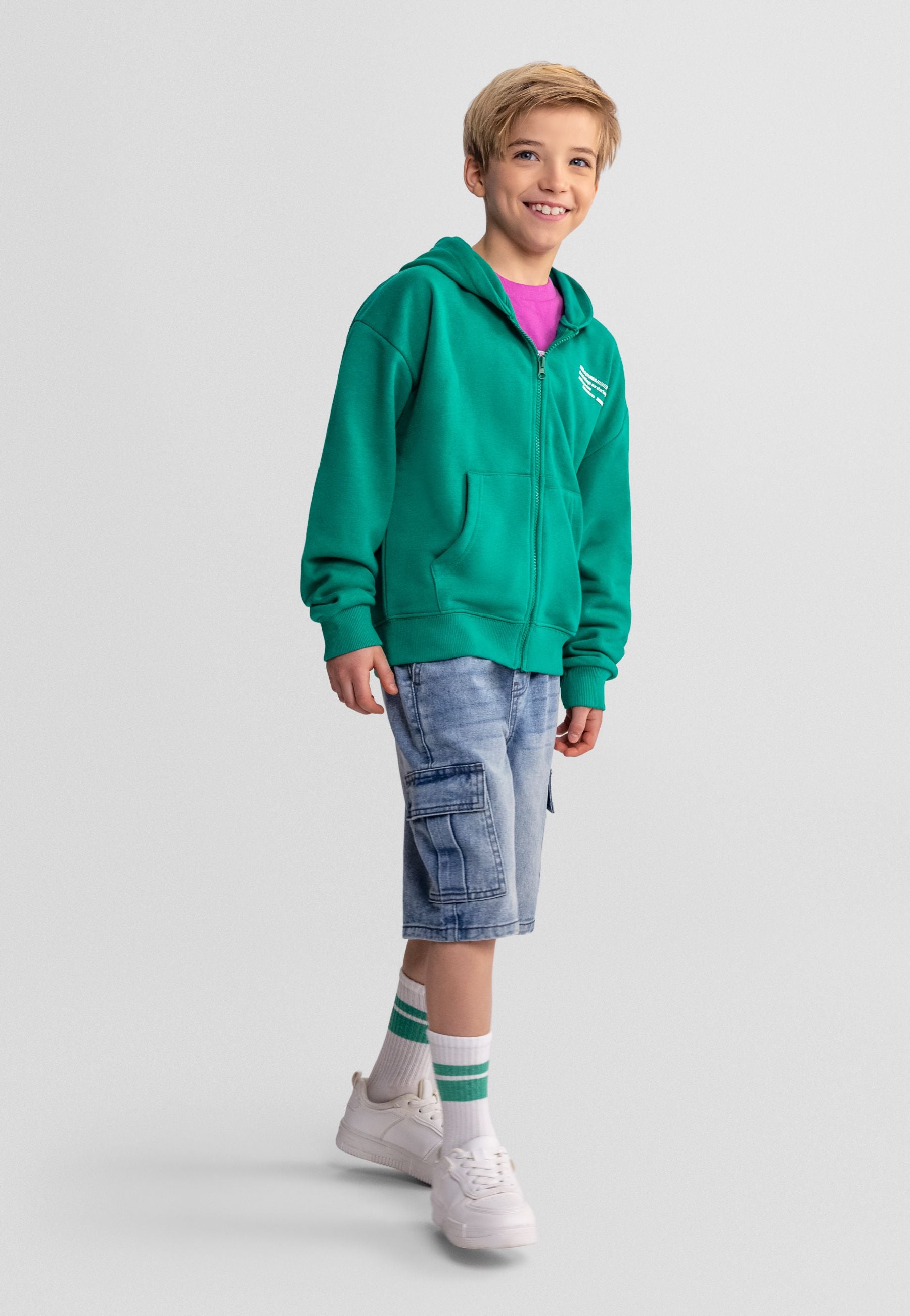 Close-up detail of light blue denim cargo shorts showing Minoti label, elastic waistband with rope drawstring and cargo pocket construction