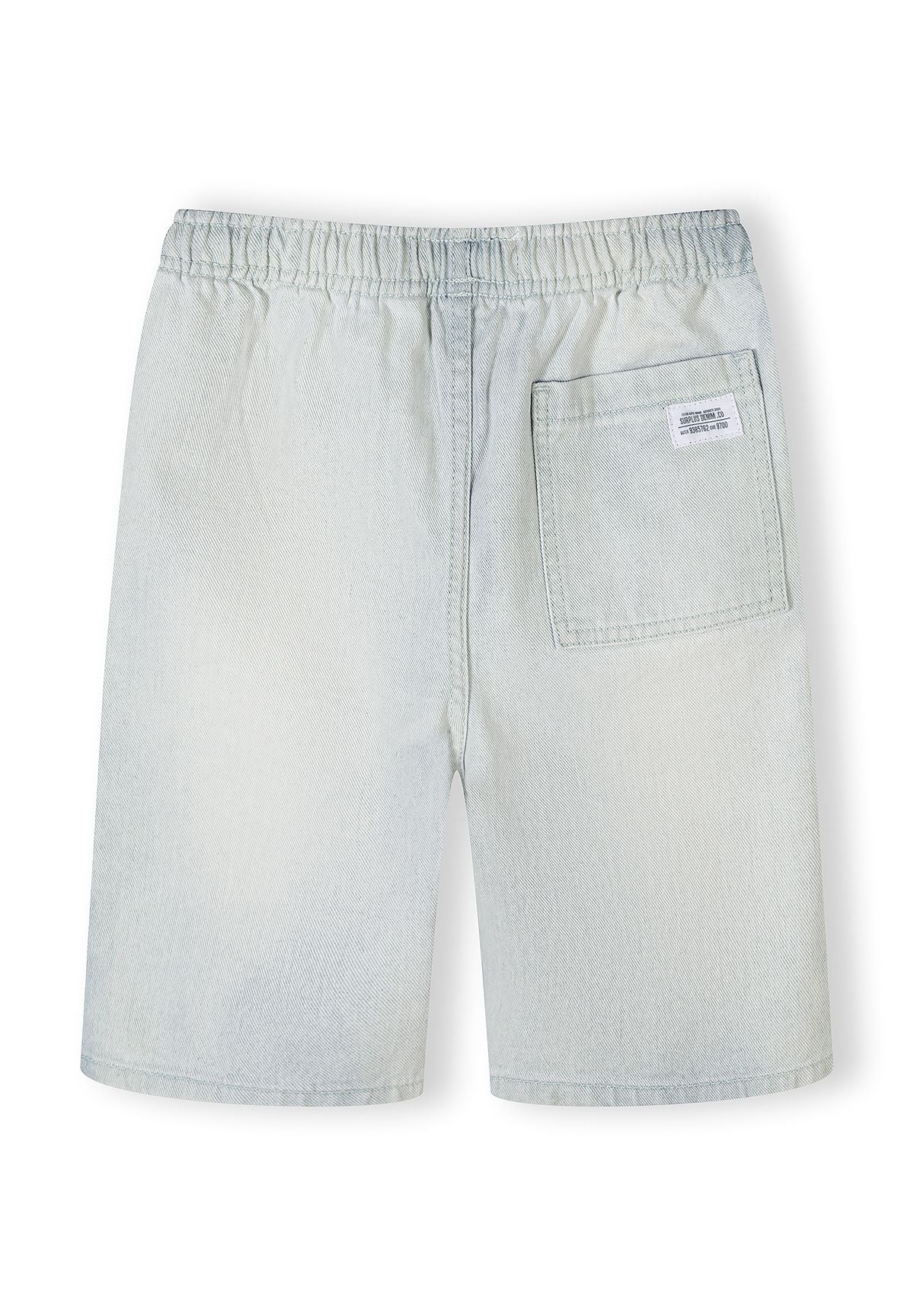 Close-up detail of denim shorts waistband showing elastic construction, cream-colored drawstring ties, and denim texture