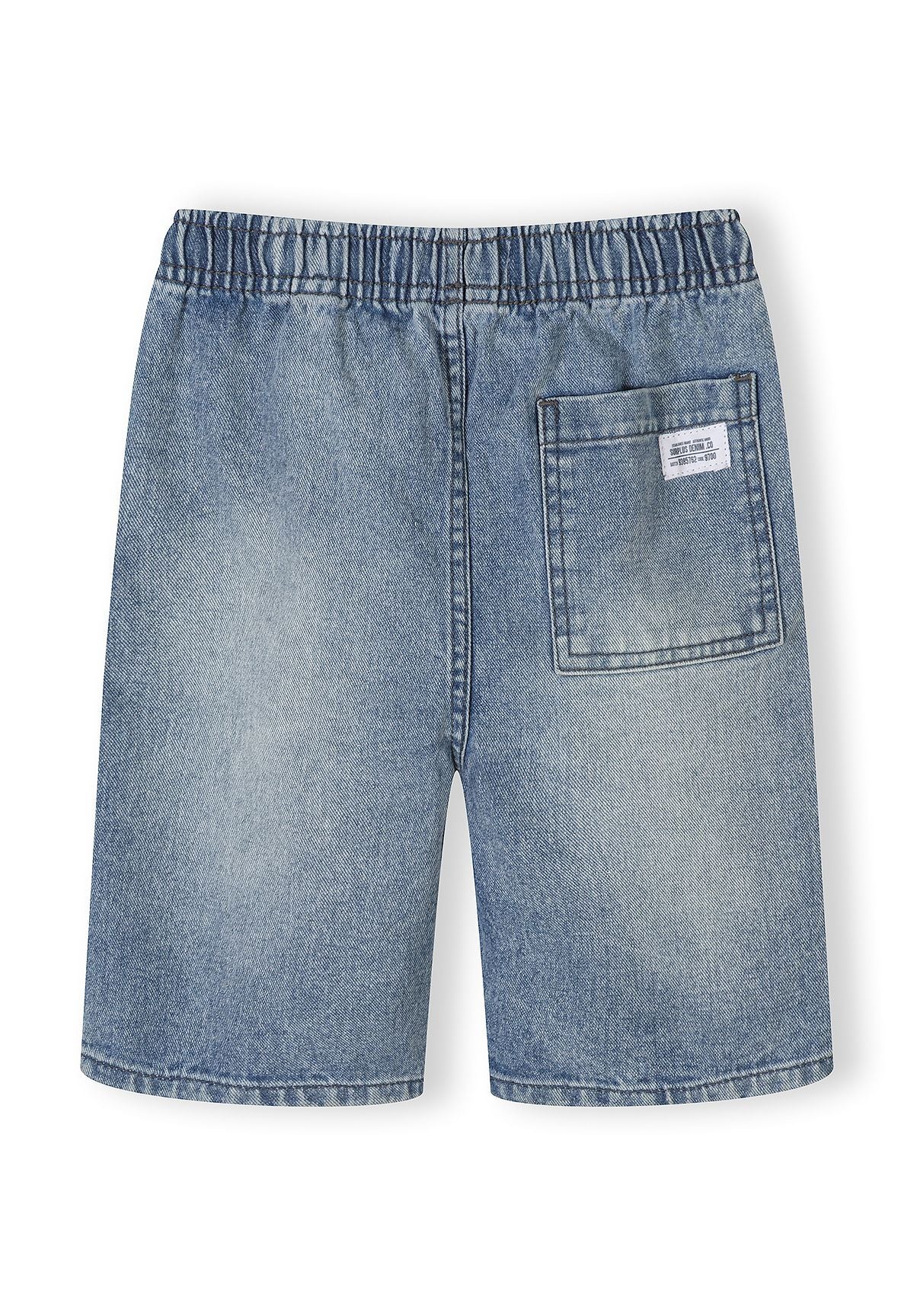 Detail of blue denim shorts with elasticated waistband and back pocket.
