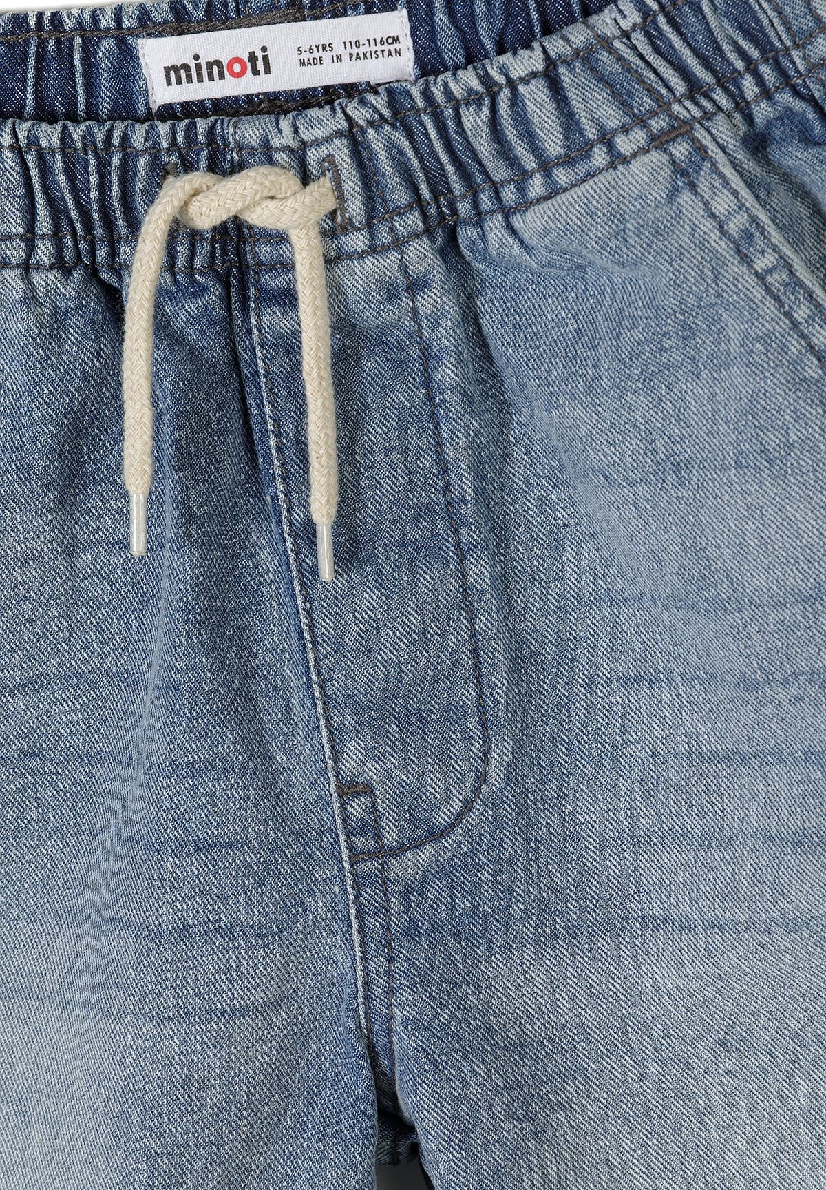 Detail of blue denim shorts with elasticated waistband and drawstring.