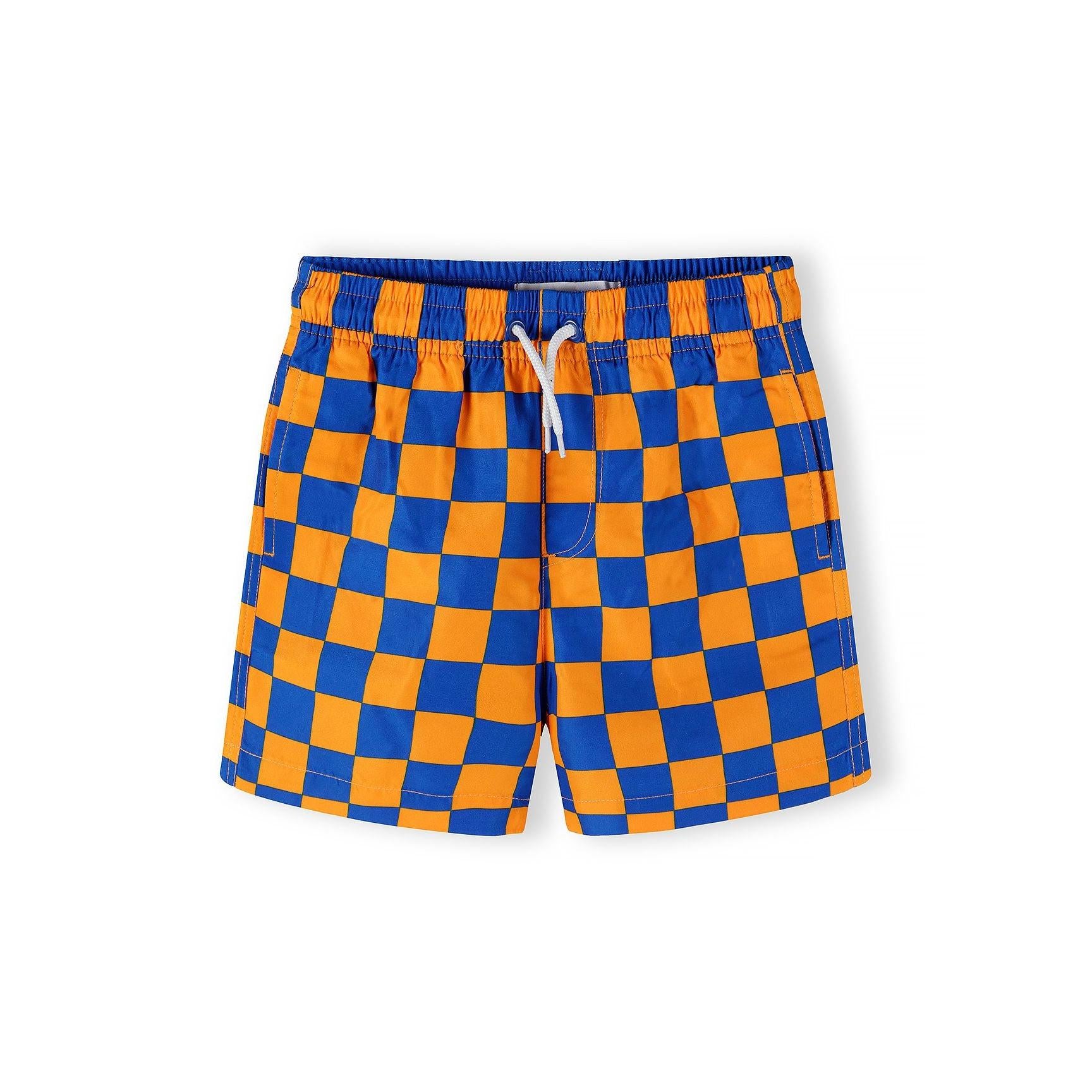 Close-up detail of orange and blue checkerboard pattern swim shorts showing elastic waistband with white drawstring cord